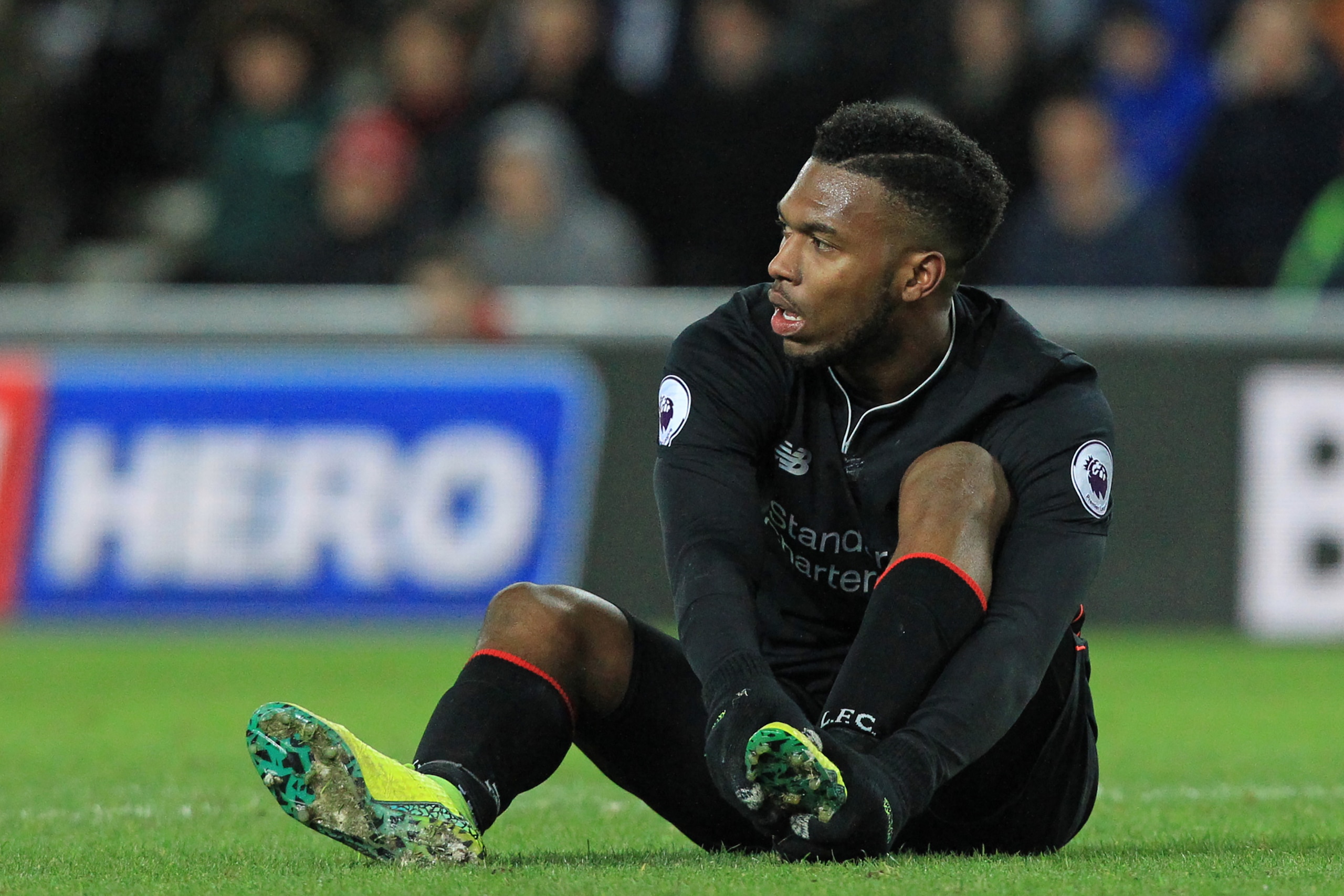 Liverpool's English striker Daniel Sturridge holds his foot after appearing to pick up an injury during the English Premier League football match between Sunderland and Liverpool at the Stadium of Light in Sunderland, north-east England on January 2, 2017