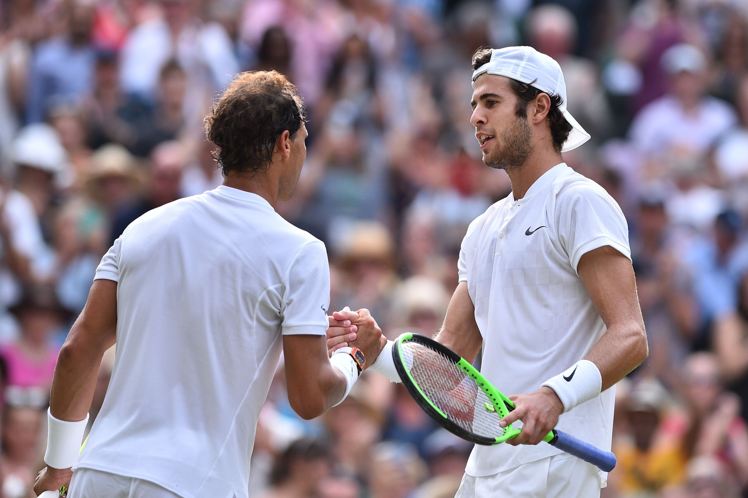 Russia's Karen Khachanov (R) shakes hands with Spain's Rafael Nadal (L) after Nadal won their men's singles third round match on the fifth day of the 2017 Wimbledon Championships at The All England Lawn Tennis Club in Wimbledon, southwest London, on July 