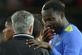Manchester United's Portuguese manager Jose Mourinho (L) talks with Everton's Belgian striker Romelu Lukaku (R) at the end of the friendly Wayne Rooney testimonial football match between Manchester United and Everton at Old Trafford in Manchester, northwe