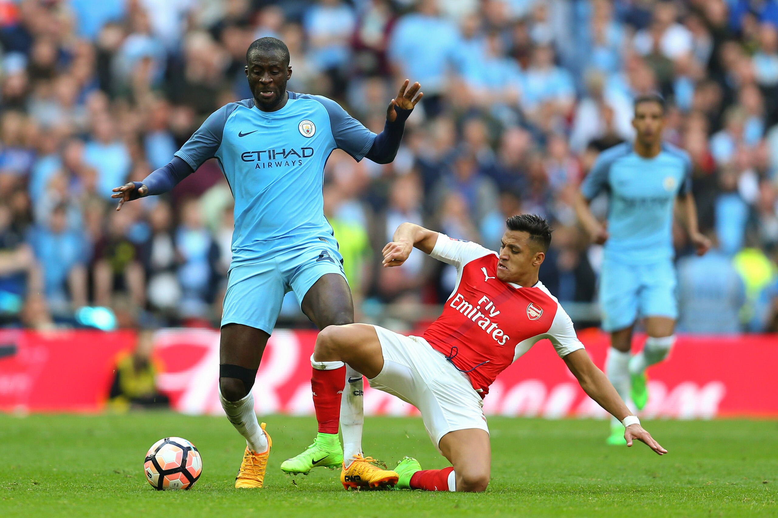 LONDON, ENGLAND - APRIL 23: Yaya Toure of Manchester City is tackled by Alexis Sanchez of Arsenal during the Emirates FA Cup semi-final match between Arsenal and Manchester City at Wembley Stadium on April 23, 2017 in London, England. (Photo by Catherine 
