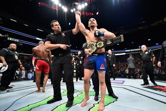 LAS VEGAS, NV - JULY 08:  (R-L) Robert Whittaker of New Zealand celebrates his victory over Yoel Romero of Cuba in their interim UFC middleweight championship bout during the UFC 213 event at T-Mobile Arena on July 8, 2017 in Las Vegas, Nevada.  (Photo by