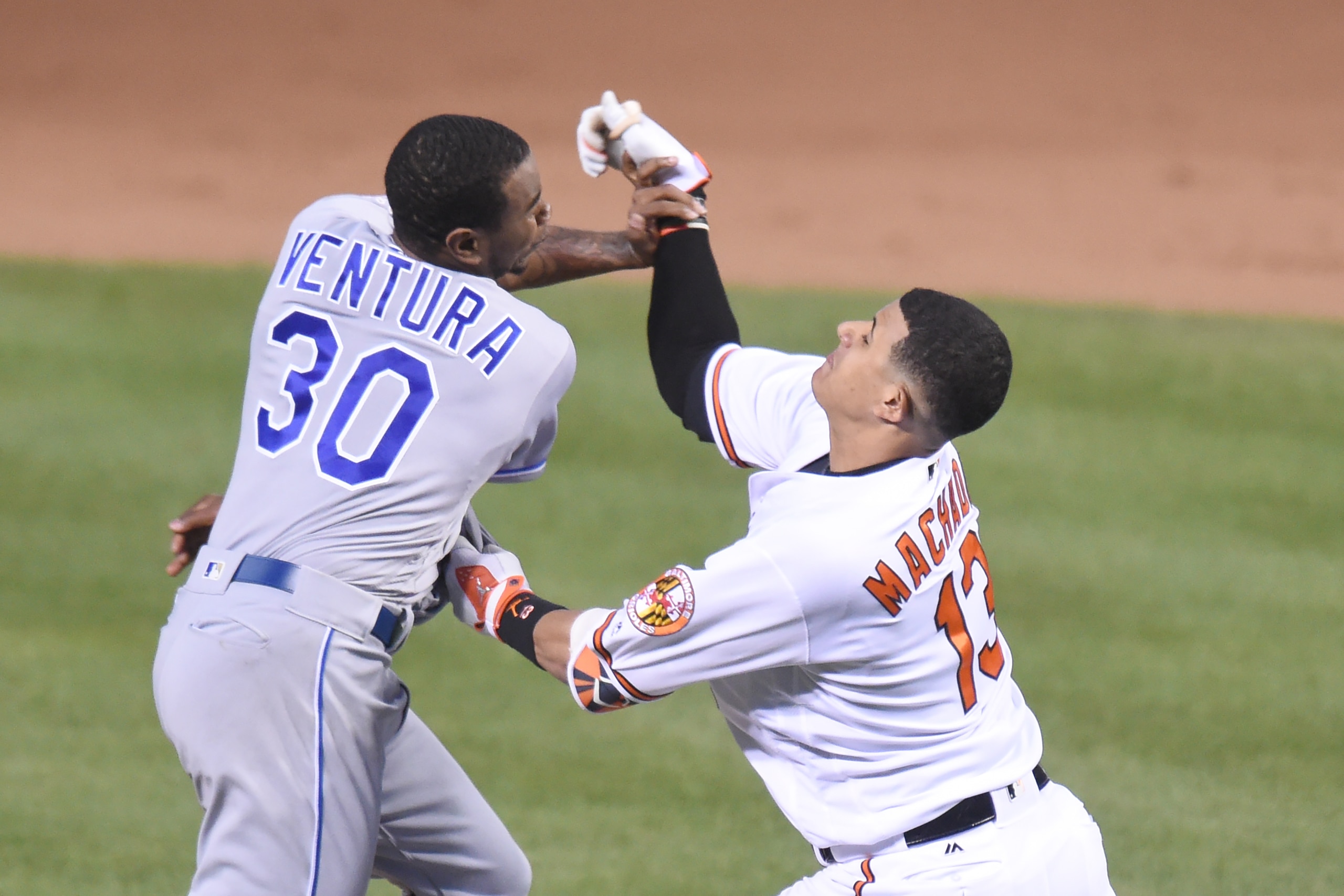 BALTIMORE, MD - JUNE 07:  Yordano Ventura #30 of the Kansas City Royals and Manny Machado #13 of the Baltimore Orioles fight during a baseball game at Oriole Park at Camden Yards on June 7, 2016 in Baltimore, Maryland.  The Orioles won 9-1.  (Photo by Mit