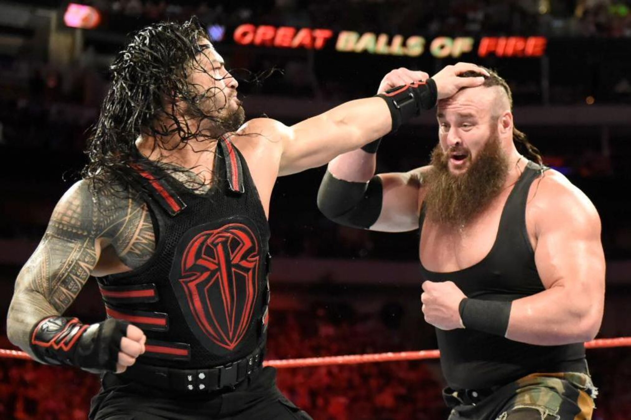 Roman Reigns on the attack against Braun Strowman.
