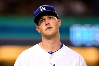 LOS ANGELES, CA - JULY 05:  Alex Wood #57 of the Los Angeles Dodgers reacts to a bunt single from Gregor Blanco #5 of the Arizona Diamondbacks during the sixth inning at Dodger Stadium on July 5, 2017 in Los Angeles, California.  (Photo by Harry How/Getty
