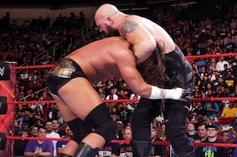 Big Show grabs hold of Big Cass.