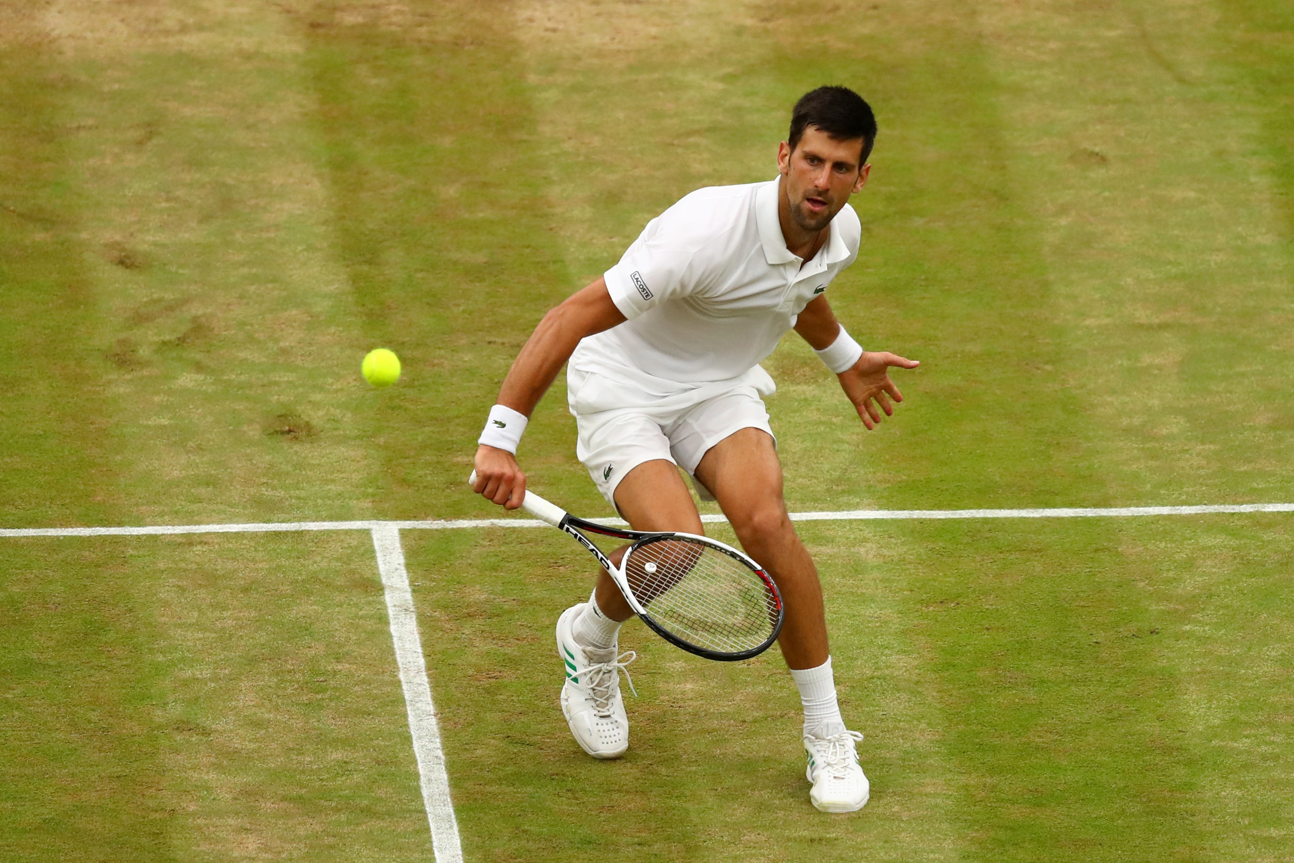 LONDON, ENGLAND - JULY 11:  Novak Djokovic of Serbia plays a backhand during the Gentlemen's Singles fourth round match against Adrian Mannarino of France on day eight of the Wimbledon Lawn Tennis Championships at the All England Lawn Tennis and Croquet C