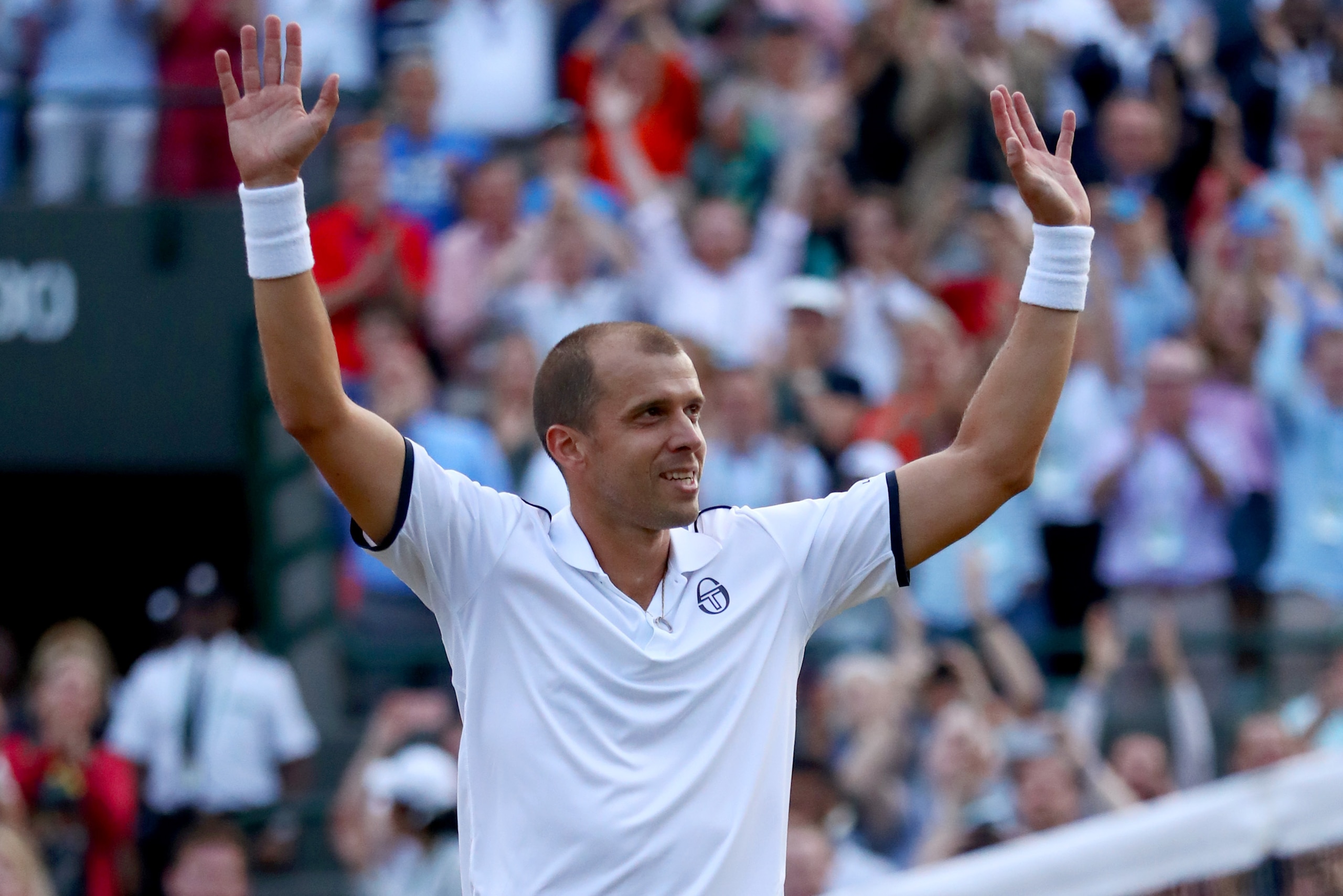 LONDON, ENGLAND - JULY 10:  Gilles Muller of Luxembourg celebrates victory after the Gentlemen's Singles fourth round match against Rafael Nadal of Spain on day seven of the Wimbledon Lawn Tennis Championships at the All England Lawn Tennis and Croquet Cl
