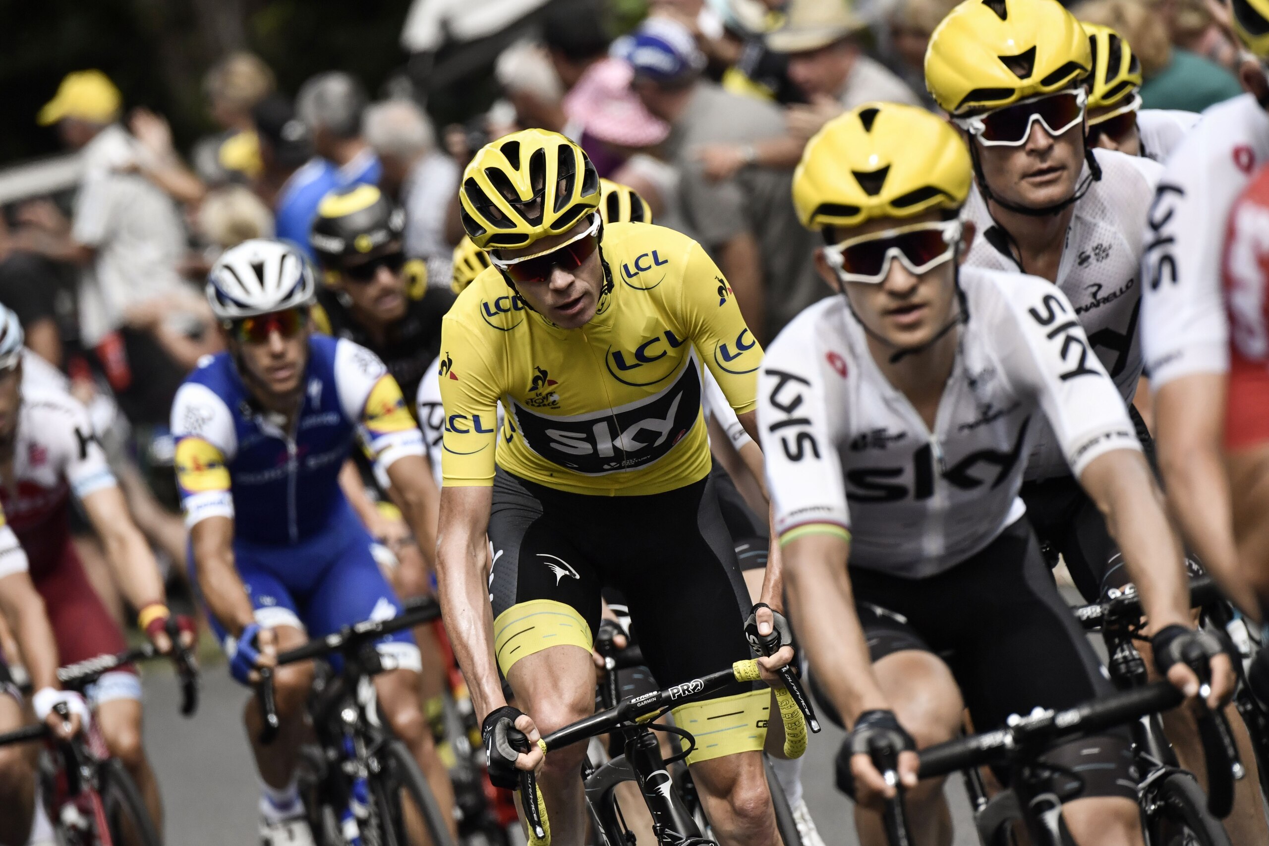 Great Britain's Christopher Froome (C), wearing the overall leader's yellow jersey, rides behind his teammates Belarus' Vasil Kiryienka (R) and Poland's Michal Kwiatkowski (2ndR) during the 178 km tenth stage of the 104th edition of the Tour de France cyc Great Britain's Christopher Froome (C), wearing the overall leader's yellow jersey, rides behind his teammates Belarus' Vasil Kiryienka (R) and Poland's Michal Kwiatkowski (2ndR) during the 178 km tenth stage of the 104th edition of the Tour de France cyc