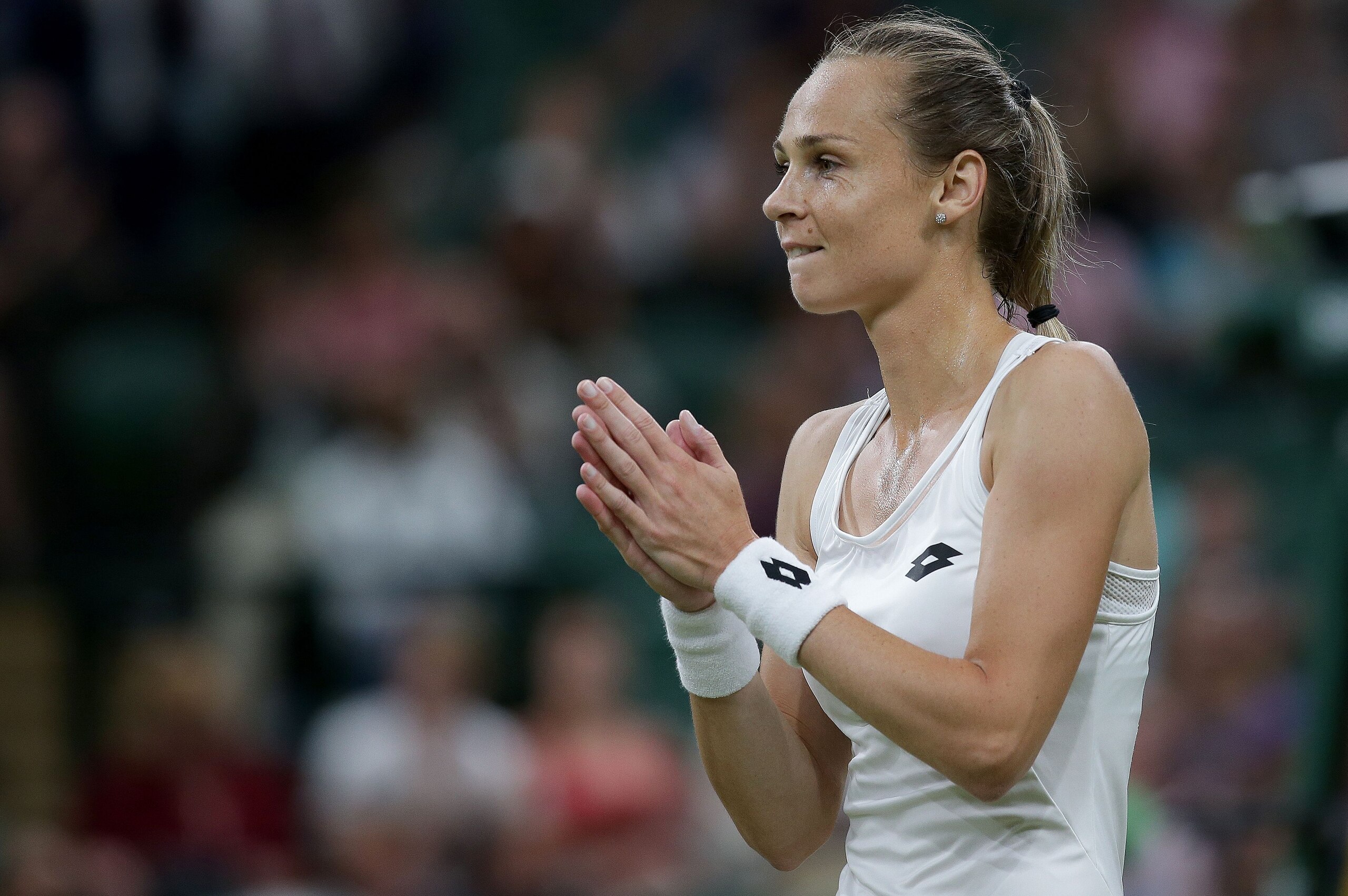 Slovakia's Magdalena Rybarikova reacts after winning against US player Coco Vandeweghe during their women's singles quarter-final match, after it re-commenced on a covered Centre Court, after rain delayed the match on Court One, on the eighth day of the 2