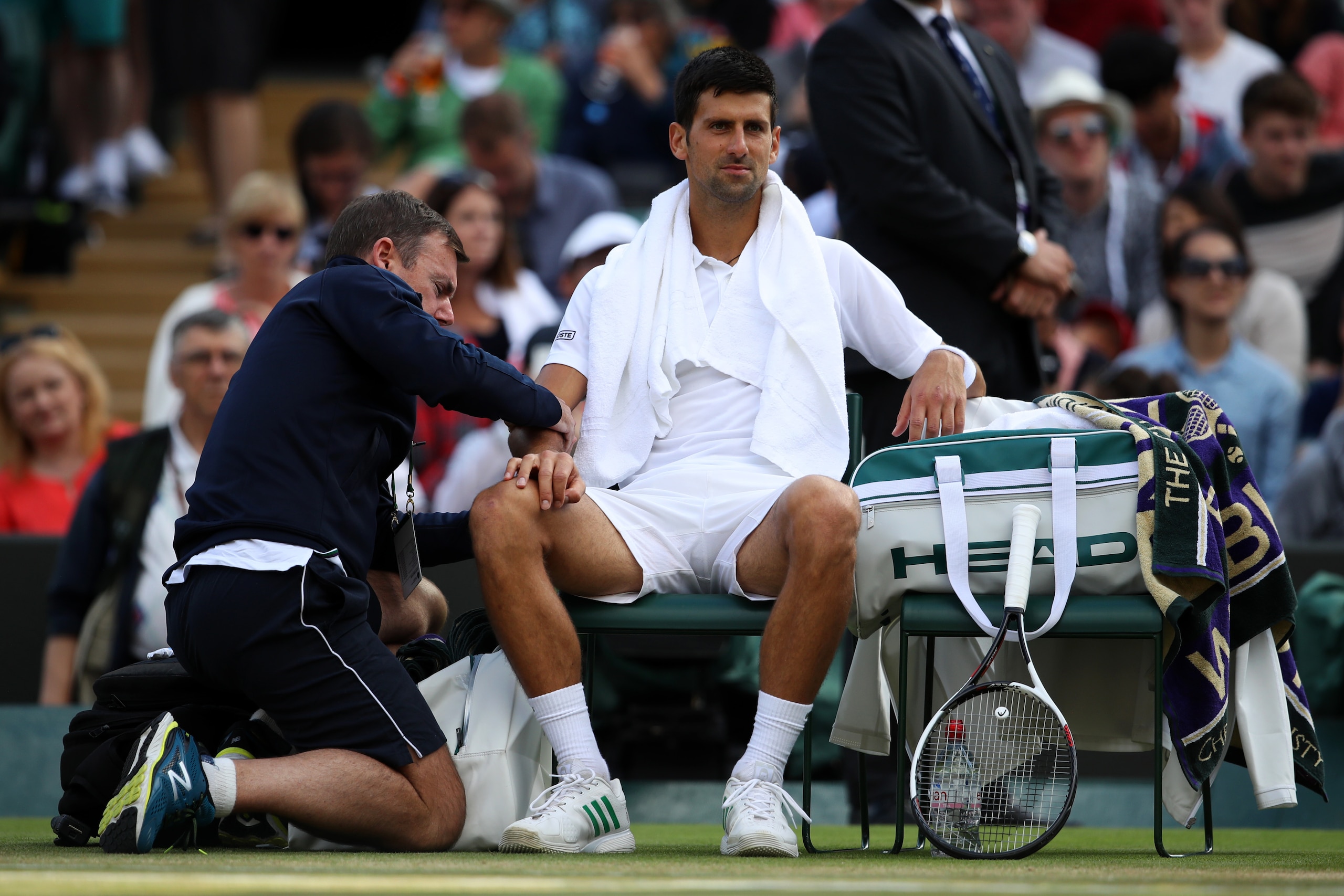 LONDON, ENGLAND - JULY 12:  Novak Djokovic of Serbia is given treatment during the Gentlemen's Singles quarter final match against Tomas Berdych of The Czech Republic on day nine of the Wimbledon Lawn Tennis Championships at the All England Lawn Tennis an