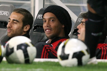 AC Milan's French midfielder Mathieu Flamini (L) and Brazilian players Ronaldinho (C) and Kaka sit on the bench during a friendly football match against Qatar's Al-Sadd in the Qatari capital Doha on March 4, 2009.  The match was played to mark the end of 