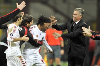 CROPPED VERSION - AC Milan's Brasilian forward Ronaldinho (C) is congratulated by AC Milan's coach Carlo Ancelotti (R) and teammates after scoring a goal few seconds before the end of the UEFA Cup group E match between AC Milan and Braga at San Siro Stadi