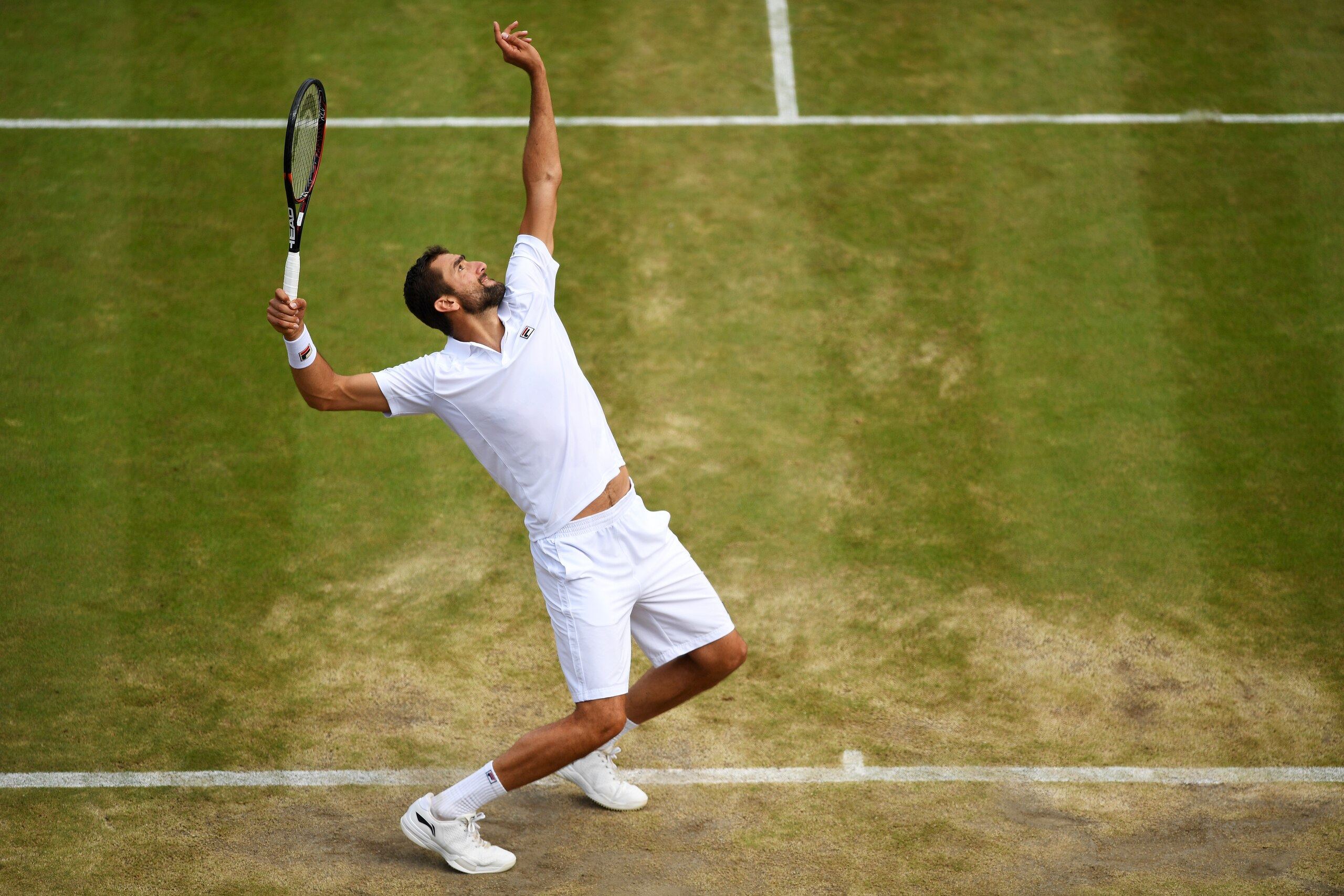 LONDON, ENGLAND - JULY 12:  Marin Cilic of Croatia serves during the Gentlemen's Singles quarter final match against Gilles Muller of Luxembourg on day nine of the Wimbledon Lawn Tennis Championships at the All England Lawn Tennis and Croquet Club on July