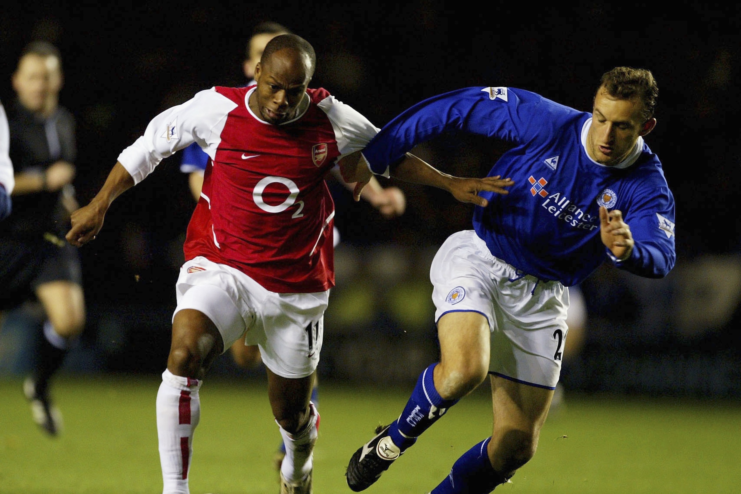 LEICESTER, ENGLAND - DECEMBER 6:  Sylvain Wiltord of Arsenal runs the ball down the line chased by Riccy Scimeca of Leicester during the FA Barclaycard Premiership match between Leicester City and Arsenal at Walkers Stadium on December 6, 2003 in Leiceste