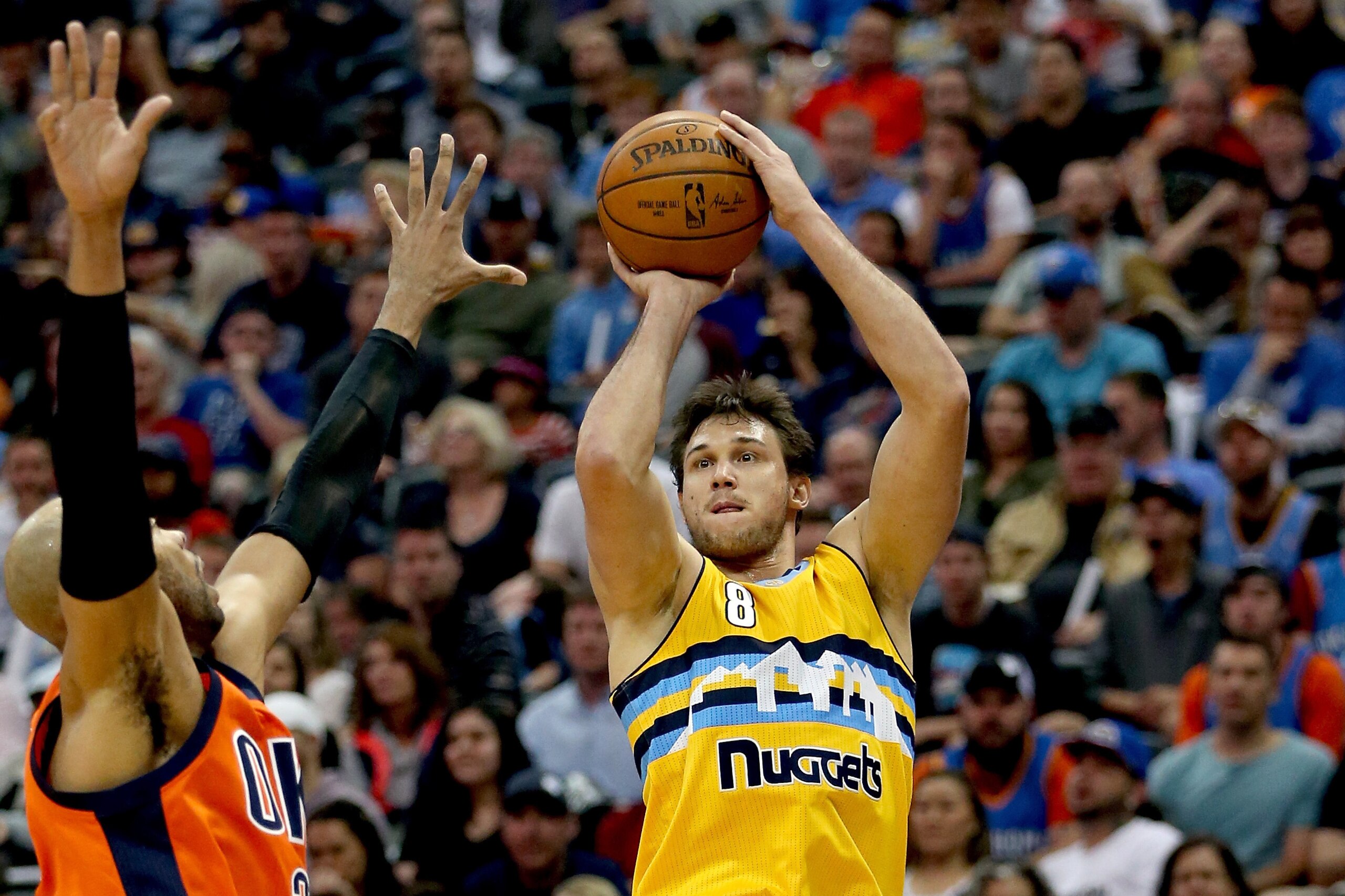 DENVER, CO - APRIL 09:  Danilo Gallinari #8 of the Denver Nuggets puts up a shot over Taj Gibson #22 of the Oklahoma City Thunder at Pepsi Center on April 9, 2017 in Denver, Colorado. NOTE TO USER: User expressly acknowledges and agrees that , by download