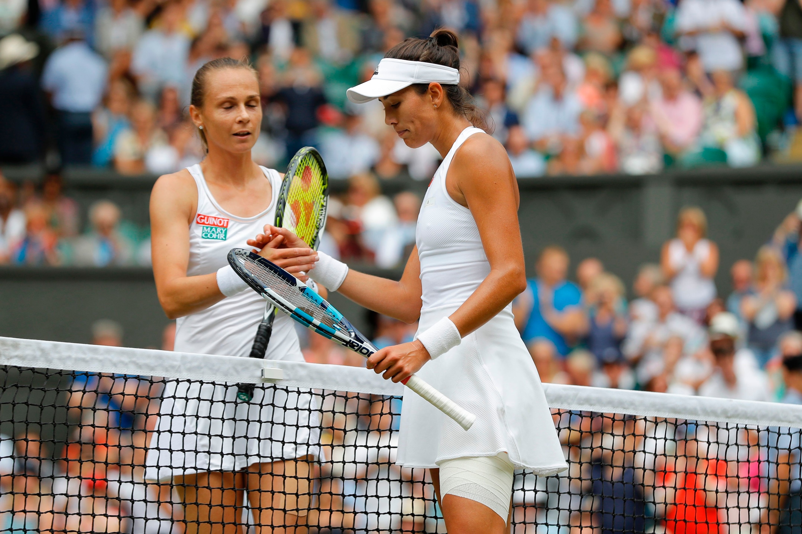 Spain's Garbine Muguruza shakes hands with Slovakia's Magdalena Rybarikova after winning their women's singles semi-final match on the tenth day of the 2017 Wimbledon Championships at The All England Lawn Tennis Club in Wimbledon, southwest London, on Jul