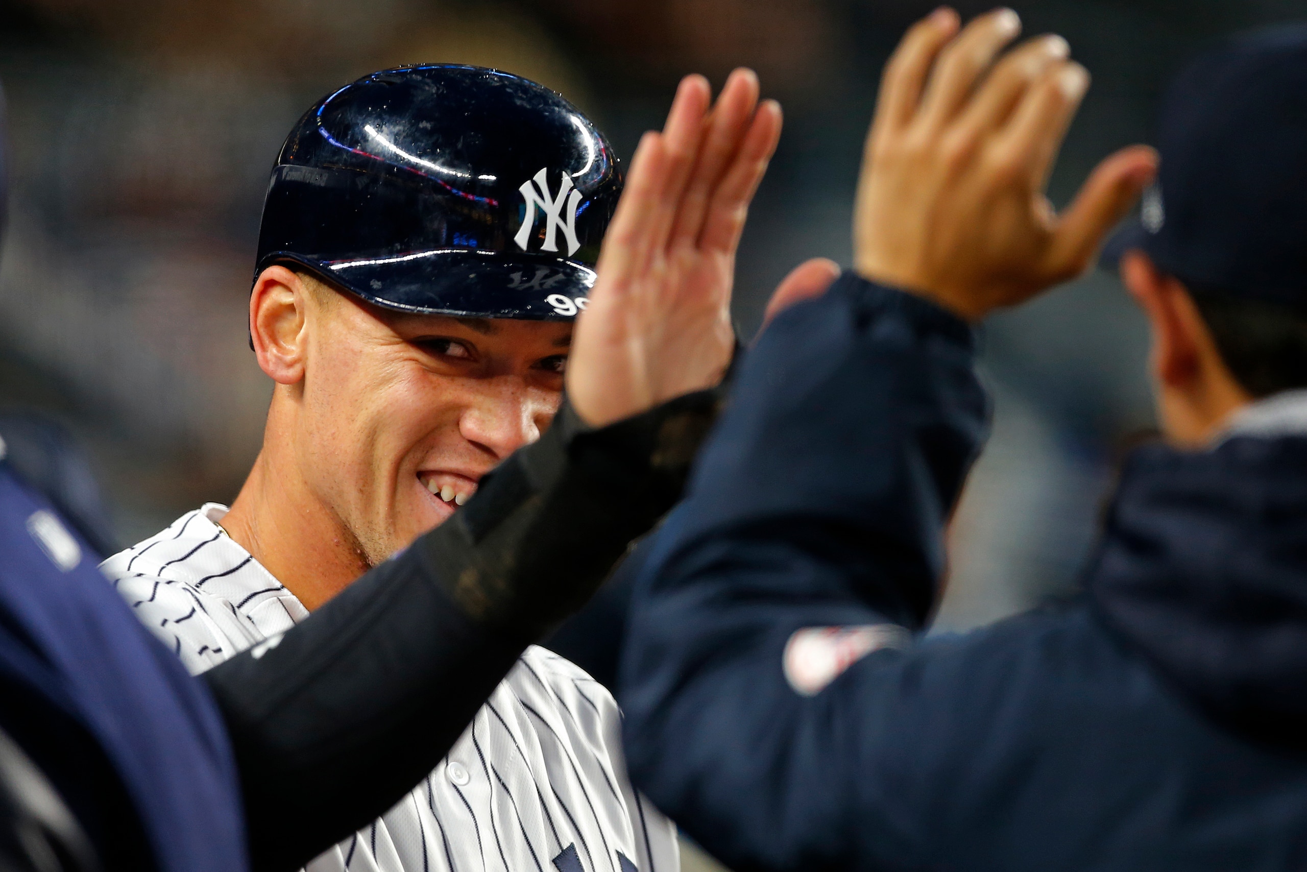 NEW YORK, NY - APRIL 19: Aaron Judge #99 of the New York Yankees is congratulated by teammates after scoring on a single by Austin Romine #27 in the second inning against the Chicago White Sox during a game at Yankee Stadium on April 19, 2017 in New York NEW YORK, NY - APRIL 19: Aaron Judge #99 of the New York Yankees is congratulated by teammates after scoring on a single by Austin Romine #27 in the second inning against the Chicago White Sox during a game at Yankee Stadium on April 19, 2017 in New York