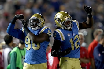PASADENA, CA - OCTOBER 01:  Takkarist McKinley #98 and Jayon Brown #12 of the UCLA Bruins react to a tackle during the second  half of a game against the Arizona Wildcats  at the Rose Bowl on October 1, 2016 in Pasadena, California.  (Photo by Sean M. Haf
