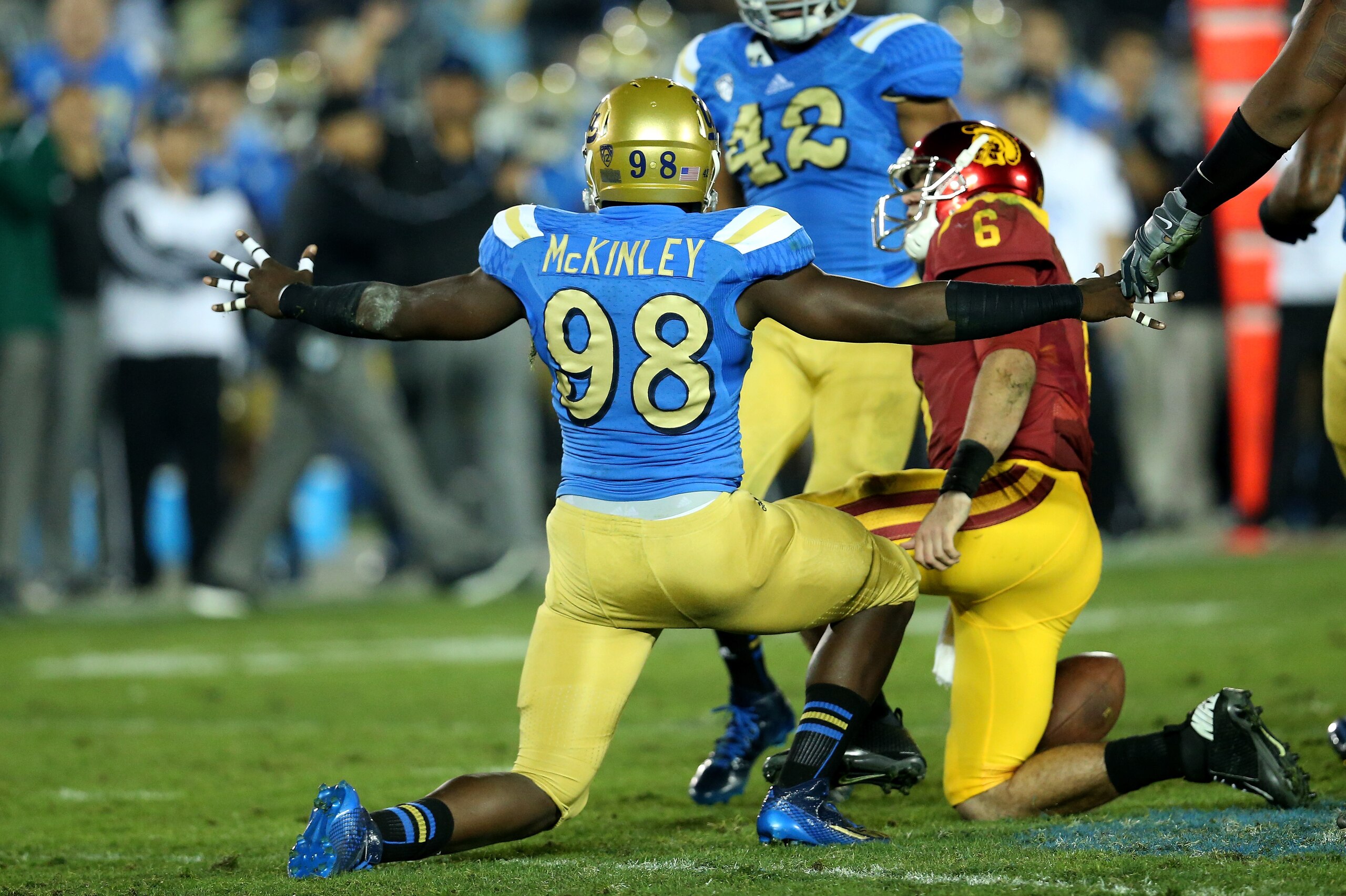 PASADENA, CA - NOVEMBER 22:  Takkarist McKinley #98 of the UCLA Bruins celebrates after sacking quarterback Cody Kessler #6 of the USC Trojans in the third quarter at the Rose Bowl on November 22, 2014 in Pasadena, California.   UCLA on 38-20.  (Photo by 