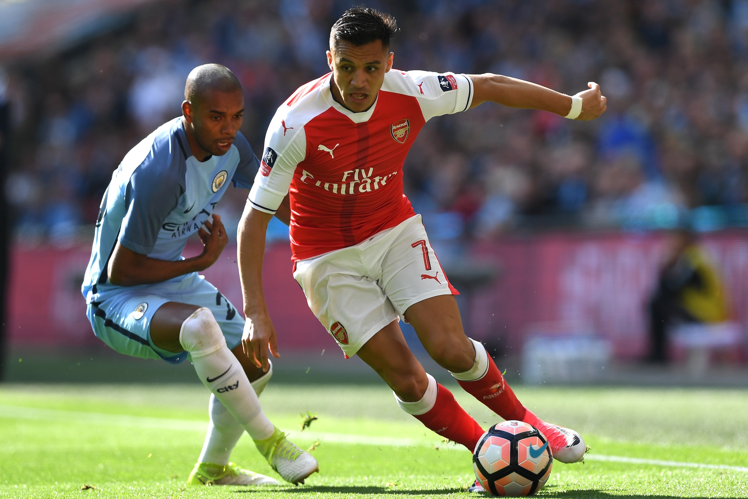 LONDON, ENGLAND - APRIL 23: Alexis Sanchez of Arsenal controls the ball under pressure of Fernandinho of Manchester City during the Emirates FA Cup Semi-Final match between Arsenal and Manchester City at Wembley Stadium on April 23, 2017 in London, Englan