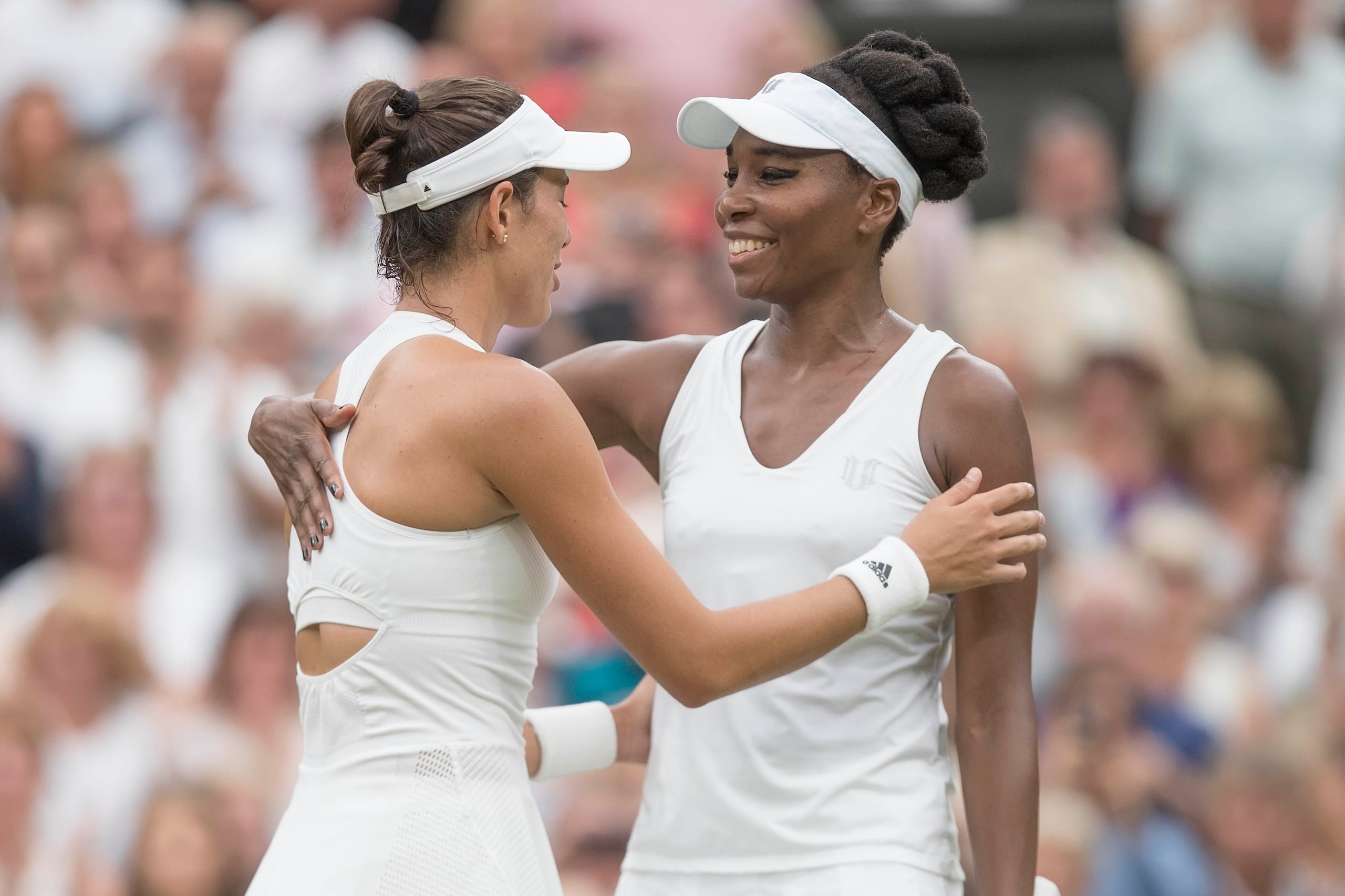 Jul 15, 2017; London, United Kingdom; Venus Williams (USA) and Garbine Muguruza (ESP) at the net after their match on day twelve at the  All England Lawn Tennis and Croquet Club. Mandatory Credit: Susan Mullane-USA TODAY Sports