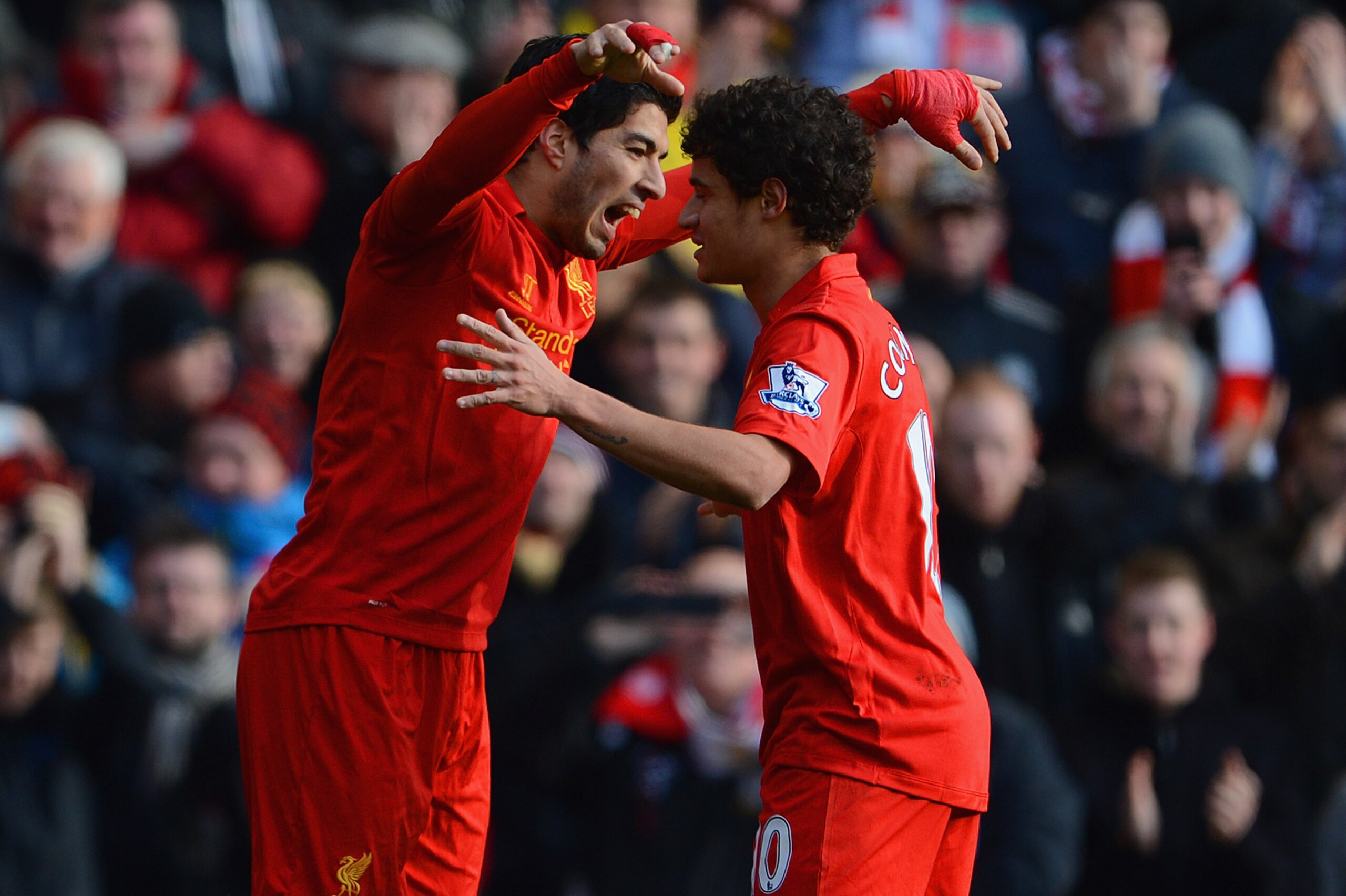 LIVERPOOL, ENGLAND - MARCH 10: Luis Suarez of Liverpool celebrates his goal to make it 1-0 with Philippe Coutinho during the Barclays Premier League match between Liverpool and Tottenham Hotspurs at Anfield on March 10, 2013 in Liverpool, England.  (Photo