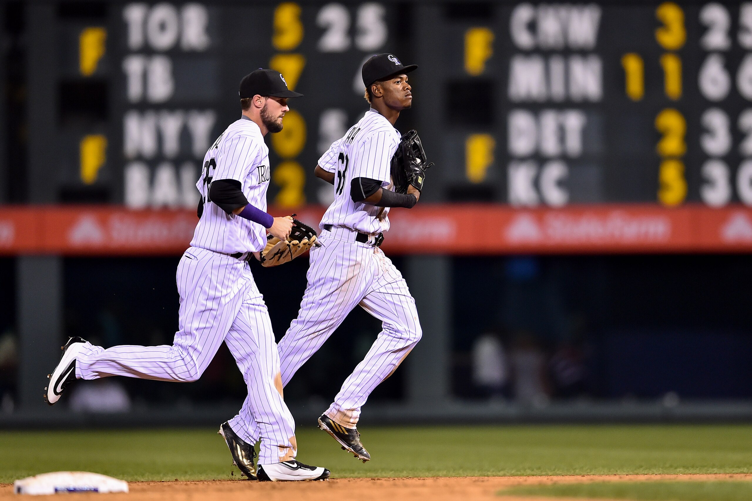 DENVER, CO - SEPTEMBER 3: Raimel Tapia #68 and David Dahl #26 of the Colorado Rockies run off the field after playing defense in the ninth inning of a game at Coors Field on September 3, 2016 in Denver, Colorado.  (Photo by Dustin Bradford/Getty Images)