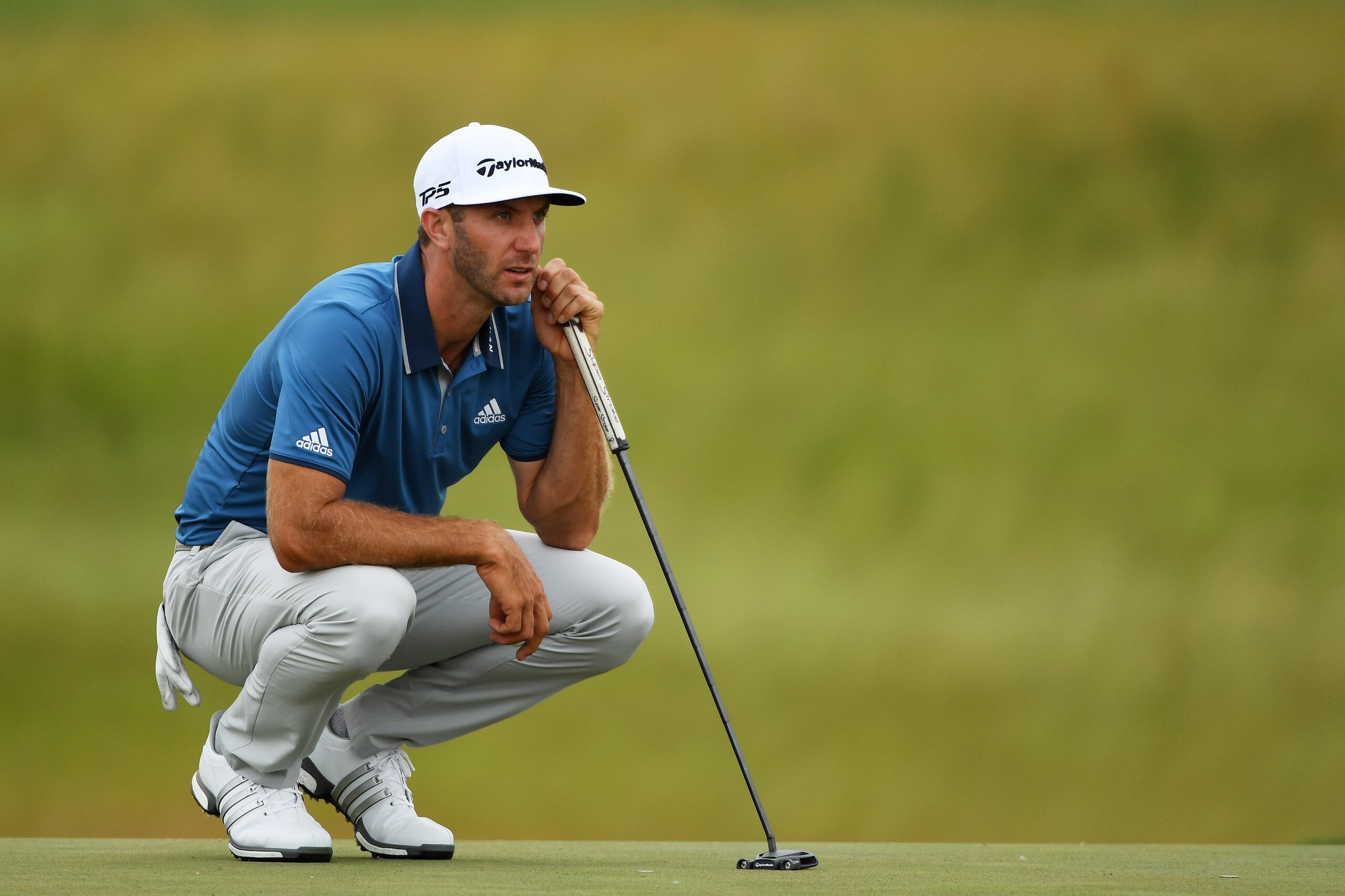 HARTFORD, WI - JUNE 16:  Dustin Johnson of the United States lines up a putt on the 18th green during the second round of the 2017 U.S. Open at Erin Hills on June 16, 2017 in Hartford, Wisconsin.  (Photo by Ross Kinnaird/Getty Images)