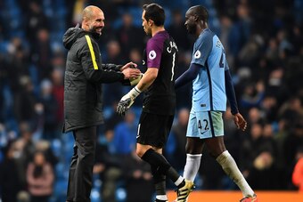 MANCHESTER, ENGLAND - DECEMBER 18: Josep Guardiola, Manager of Manchester City (L) celebrates with Claudio Bravo of Manchester City (C) and Yaya Toure of Manchester City (R) after the final whistle during the Premier League match between Manchester City a