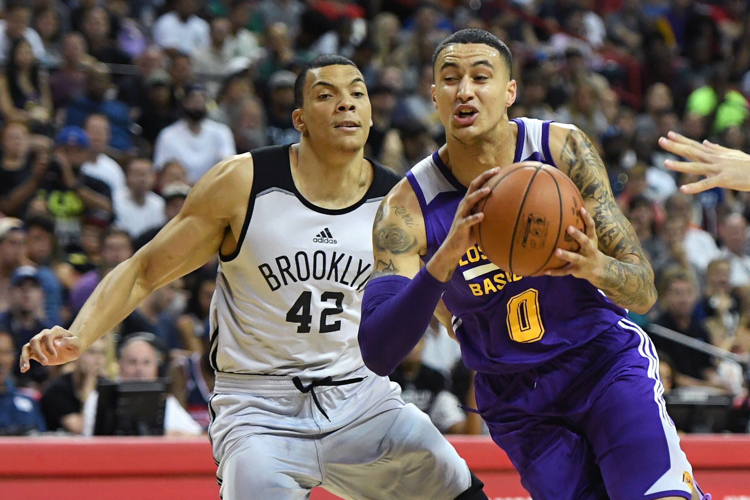 LAS VEGAS, NV - JULY 15:  Kyle Kuzma #0 of the Los Angeles Lakers drives against Jacob Wiley #42 of the Brooklyn Nets during the 2017 Summer League at the Thomas & Mack Center on July 15, 2017 in Las Vegas, Nevada. Los Angeles won 115-106. NOTE TO USER: U