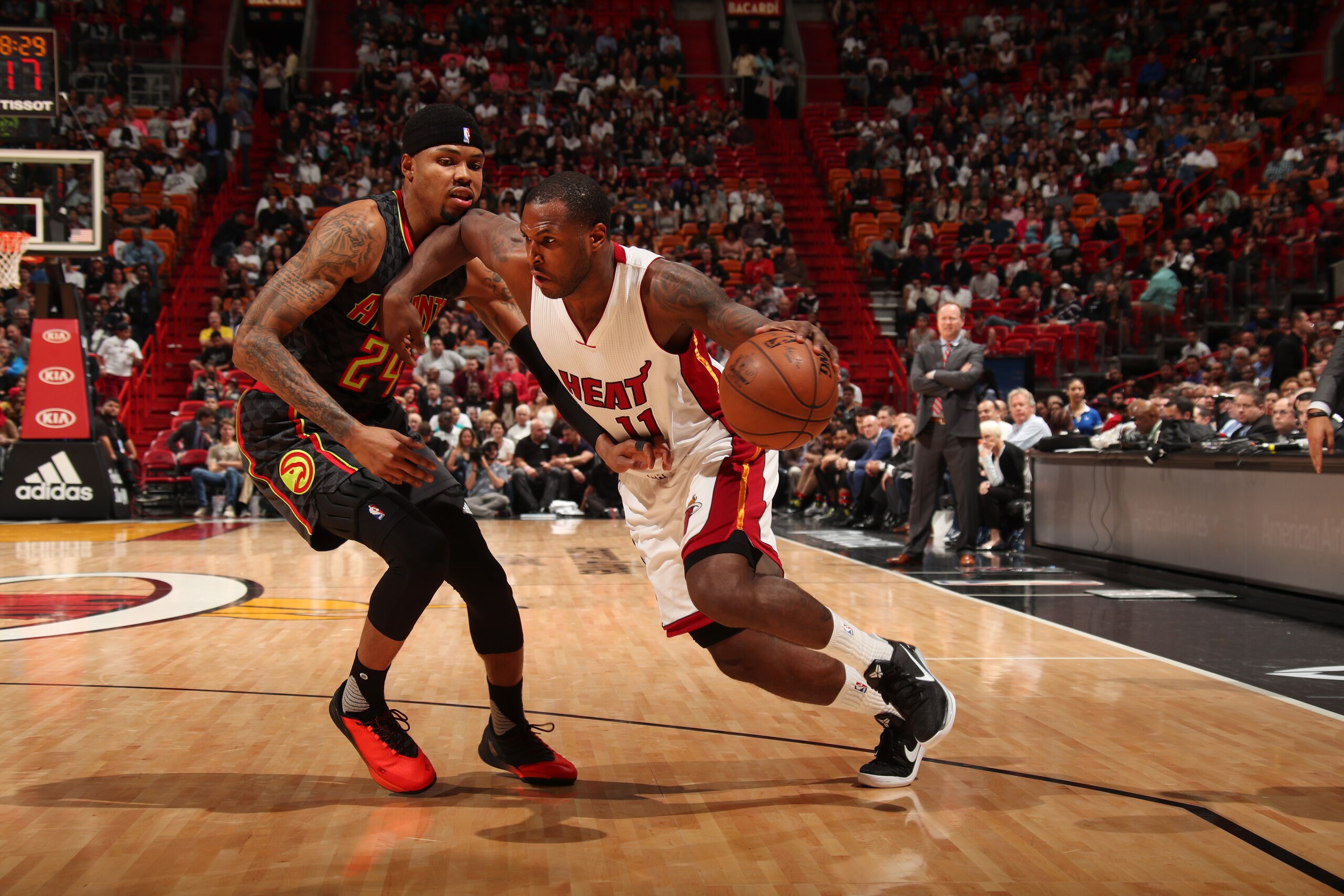 MIAMI, FL - FEBRUARY 1:  Dion Waiters #11 of the Miami Heat handles the ball against Kent Bazemore #24 of the Atlanta Hawks during a game on February 1, 2017 at American Airlines Arena in Miami, Florida. NOTE TO USER: User expressly acknowledges and agree
