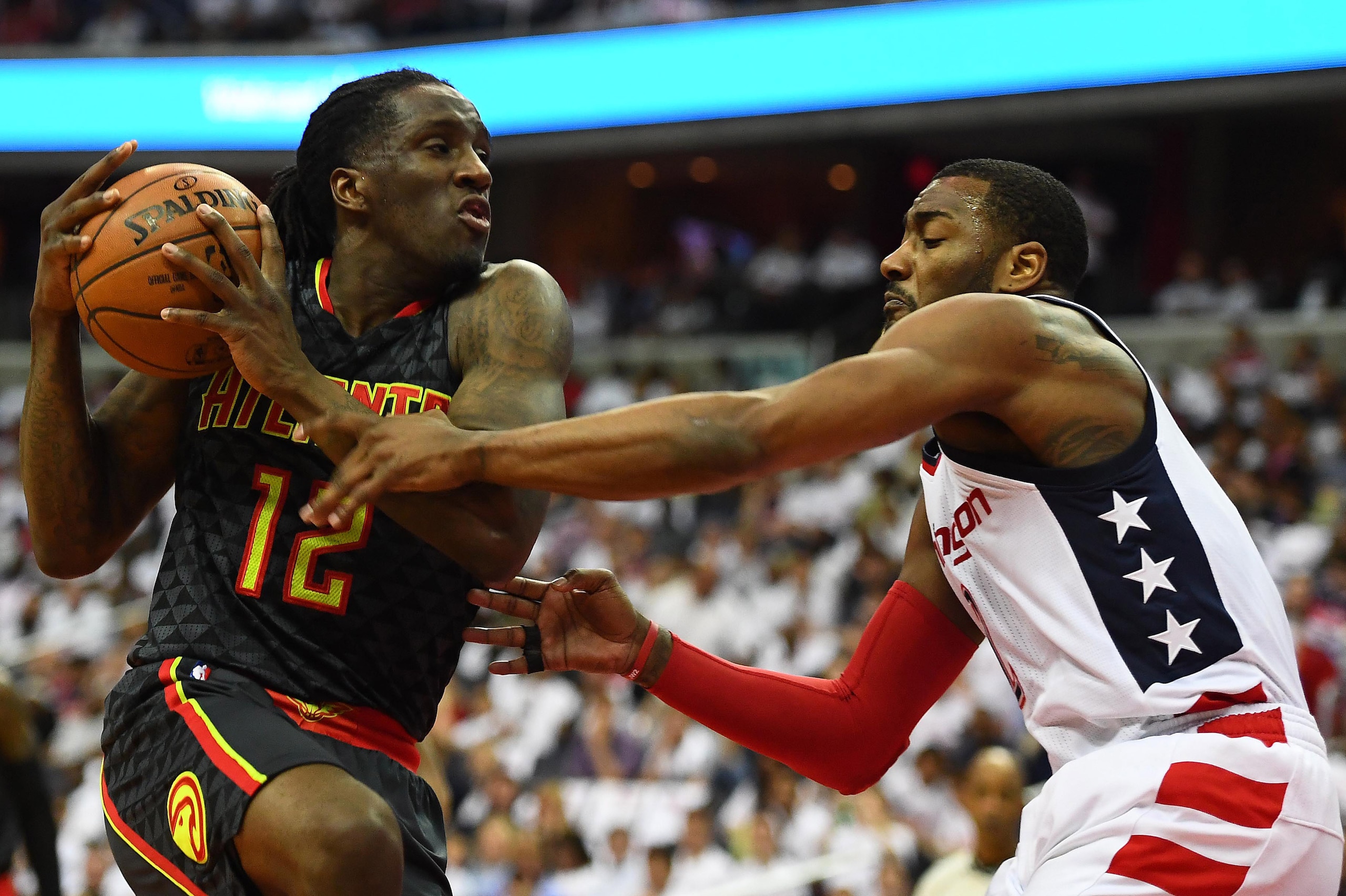 Apr 16, 2017; Washington, DC, USA; Atlanta Hawks forward Taurean Prince (12) is fouled by Washington Wizards guard John Wall (2) during the second quarter in game one of the first round of the 2017 NBA Playoffs at Verizon Center. Mandatory Credit: Brad Mi
