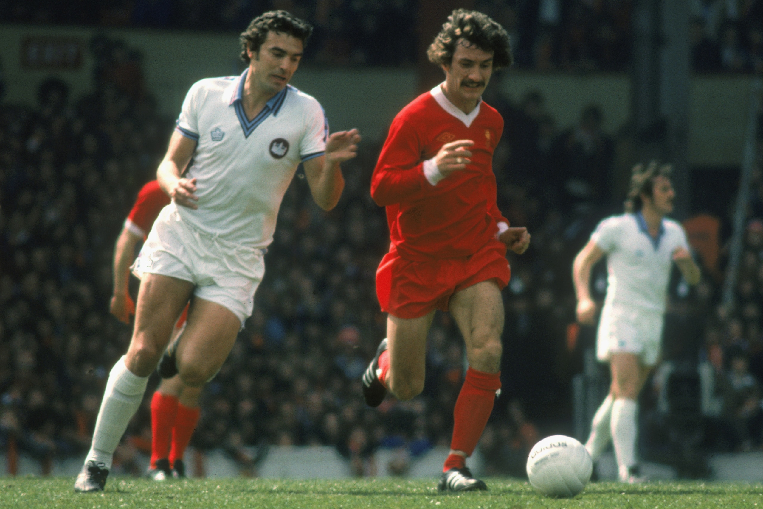 LIVERPOOL - MAY 14:  Terry McDermott of Liverpool takes the ball past Trevor Brooking of West Ham United during the League Division One match held on May 14, 1977 at Anfield, in Liverpool, England. The match ended in a 0-0 draw. (Photo by Tony Duffy/Getty