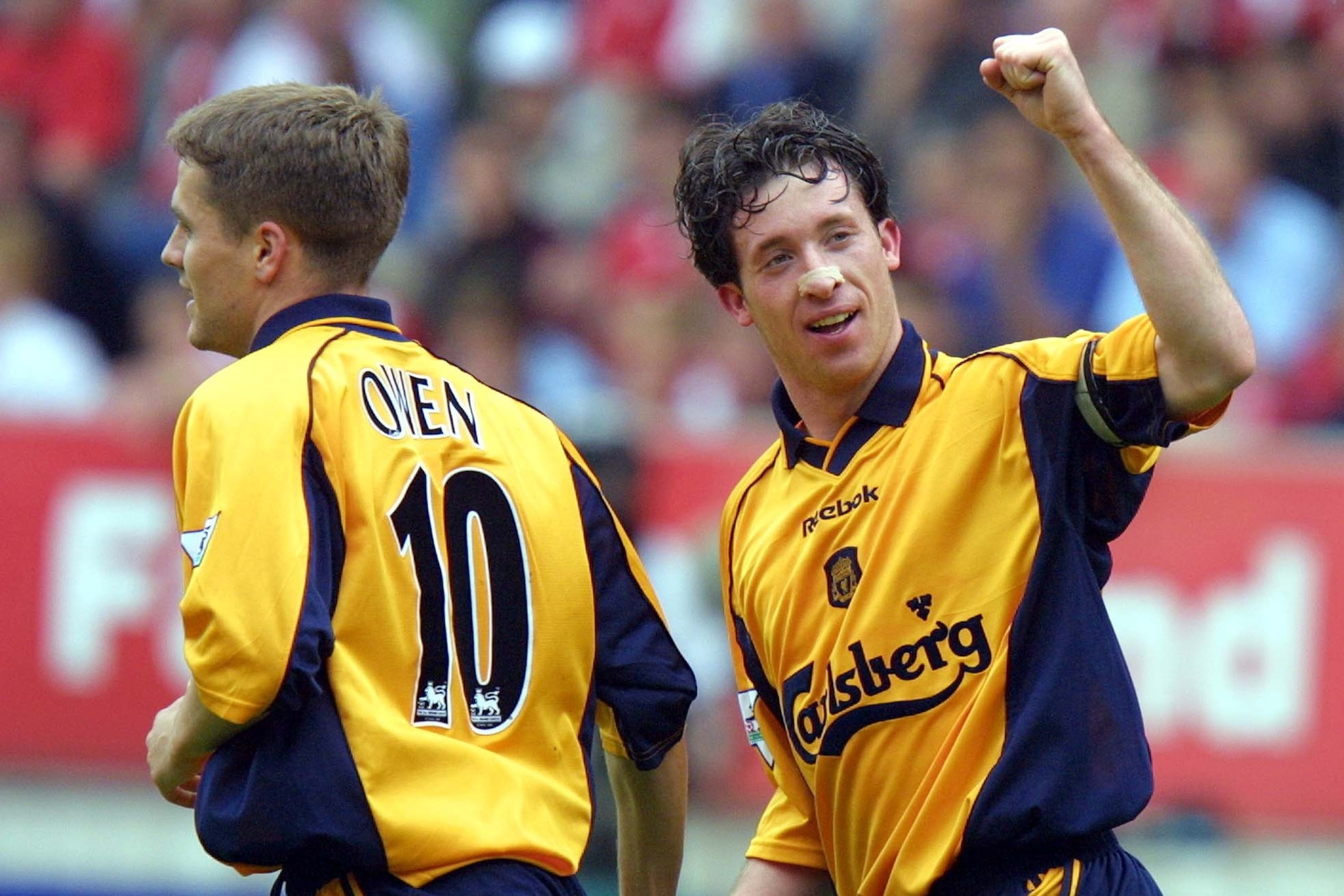 LONDON, UNITED KINGDOM:  Liverpool`s Robbie Fowler (R) celebrates scoring a goal with teammate Michael Owen 19 May 2001 during a premier league match against Charlton at the Valley stadium in South London. Liverpool is currently leading 2-O and have secur