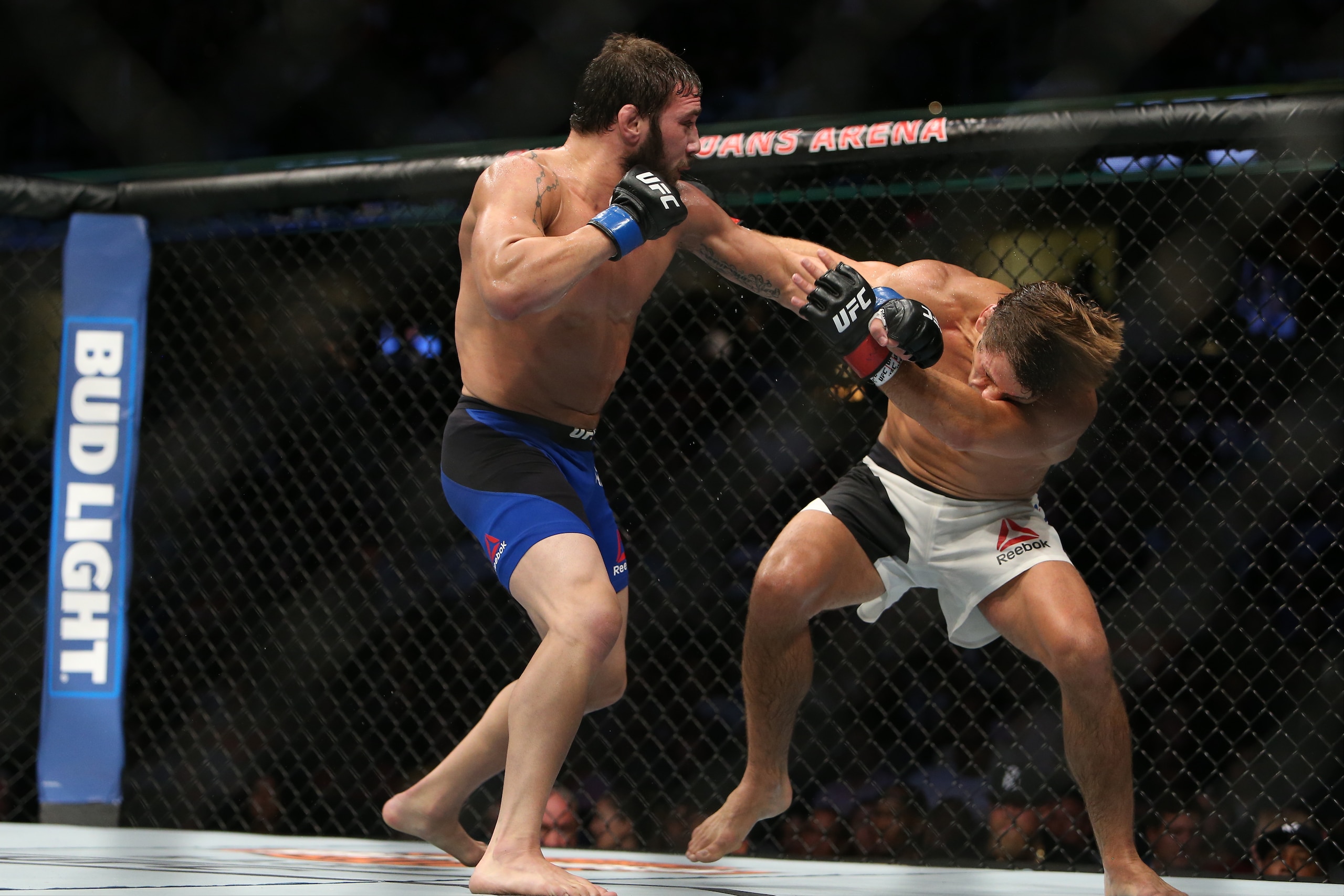 CLEVELAND, OH - SEPTEMBER 10:  Jimmie Rivera punches Urijah Faber during the UFC 203 event at Quicken Loans Arena on September 10, 2016 in Cleveland, Ohio. (Photo by Rey Del Rio/Getty Images)