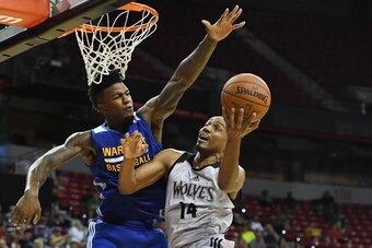 LAS VEGAS, NV - JULY 12:  C.J. Williams #14 of the Minnesota Timberwolves drives to the basket against Jordan Bell #2 of the Golden State Warriors during the 2017 Summer League at the Thomas & Mack Center on July 12, 2017 in Las Vegas, Nevada. Golden Stat