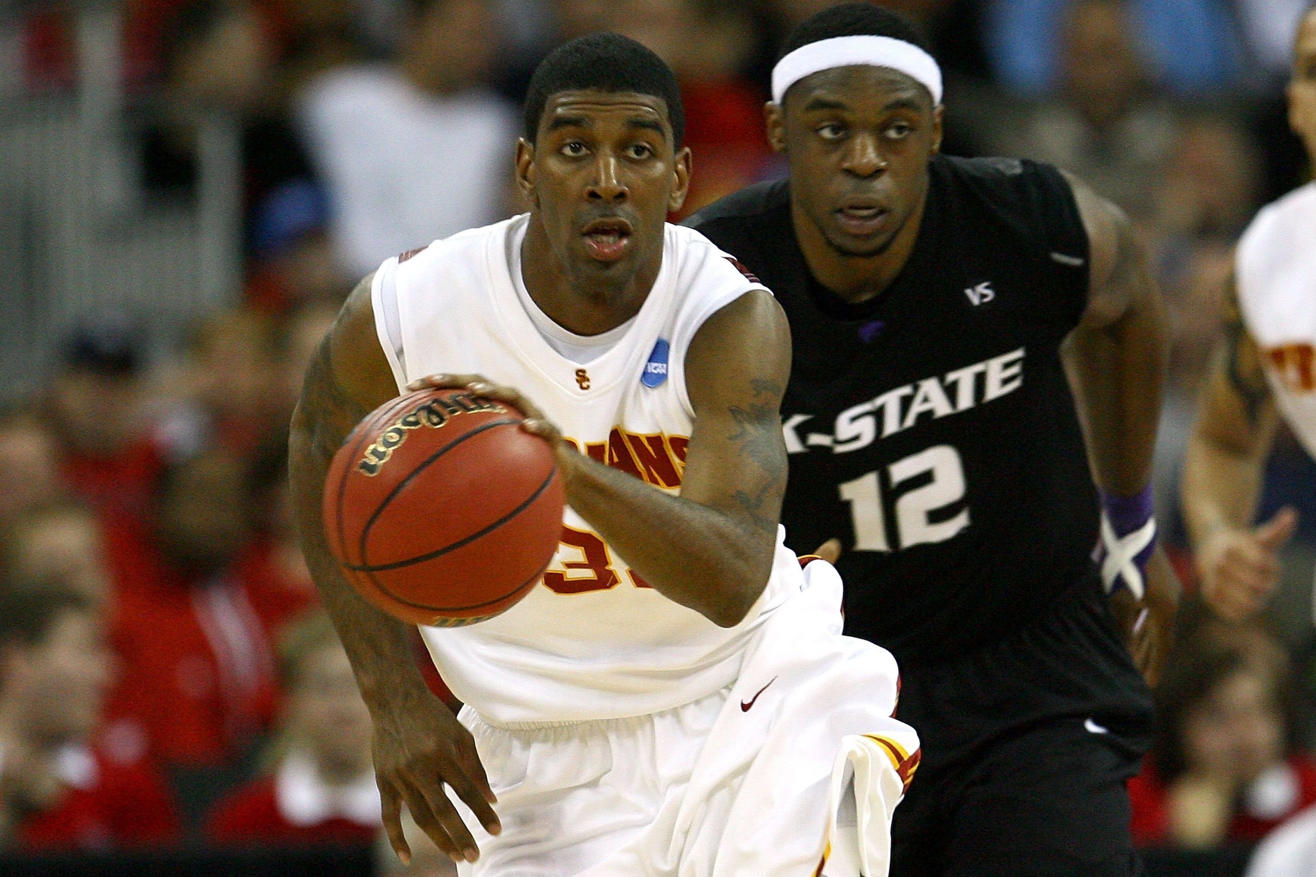 OMAHA, NE - MARCH 20:  O.J. Mayo #32 of the USC Trojans brings the ball up court ahead of Bill Walker #12 of the Kansas State Wildcats during the Midwest Region first round of the 2008 NCAA Men's Basketball Tournament on March 20, 2008 at the Qwest Center