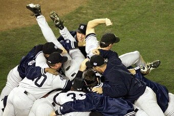 SAN DIEGO, :  Members of the New York Yankees celebrate after winning game four of the World Series against the San Diego Padres 21 October at Qualcomm Stadium in San Diego, CA.  The Yankees won the game 3-0 to sweep the series from the Padres. (ELECTRONI