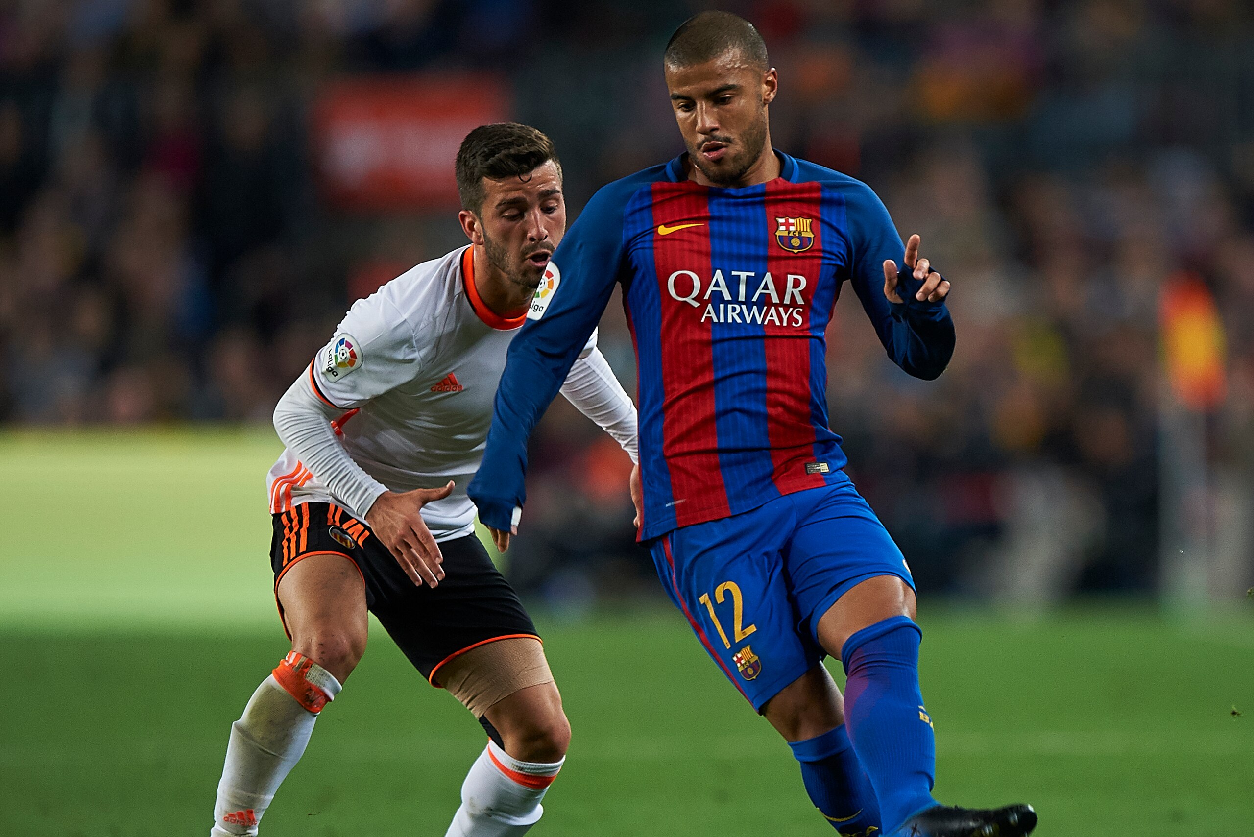 BARCELONA, SPAIN - MARCH 19:  Rafinha  (R) of Barcelona competes for the ball with Jose Luis Gaya of Valencia during the La Liga match between FC Barcelona and Valencia CF at Camp Nou Stadium on March 19, 2017 in Barcelona, Spain.  (Photo by fotopress/Get