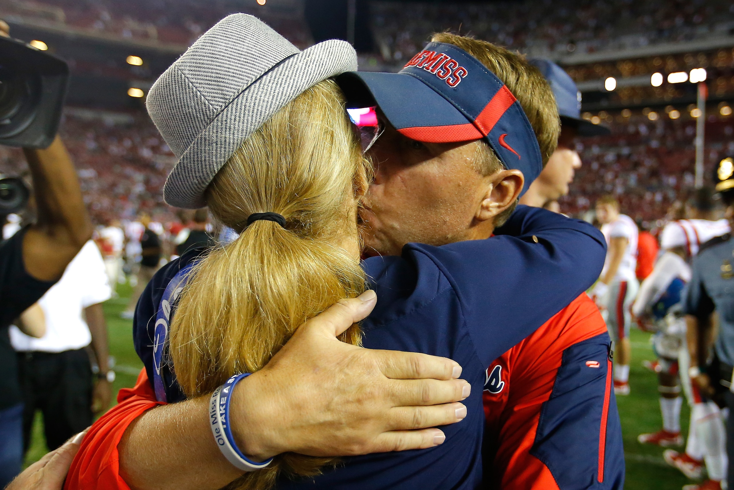 TUSCALOOSA, AL - SEPTEMBER 19:  Head coach Hugh Freeze of the Mississippi Rebels kisses his wife Jill after their 43-37 win over the Alabama Crimson Tide at Bryant-Denny Stadium on September 19, 2015 in Tuscaloosa, Alabama.  (Photo by Kevin C. Cox/Getty I