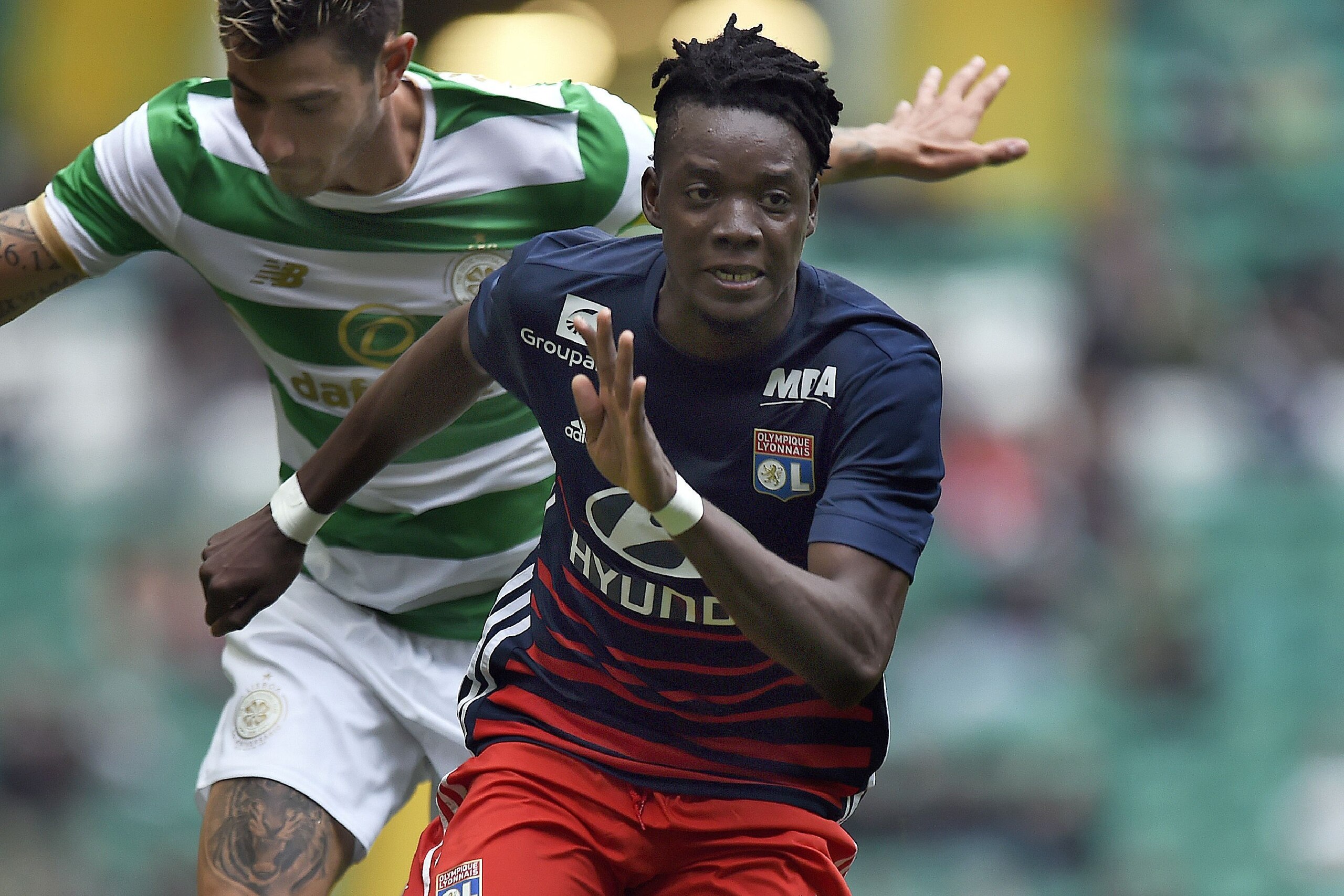 Lyon's Burkina Faso midfielder Bertrand Traore chases the ball during the pre-season friendly football match between Glasgow Celtic and Olympique Lyonnais at Celtic Park in Glasgow, Scotland on July 15, 2017. / AFP PHOTO / Andy Buchanan        (Photo cred