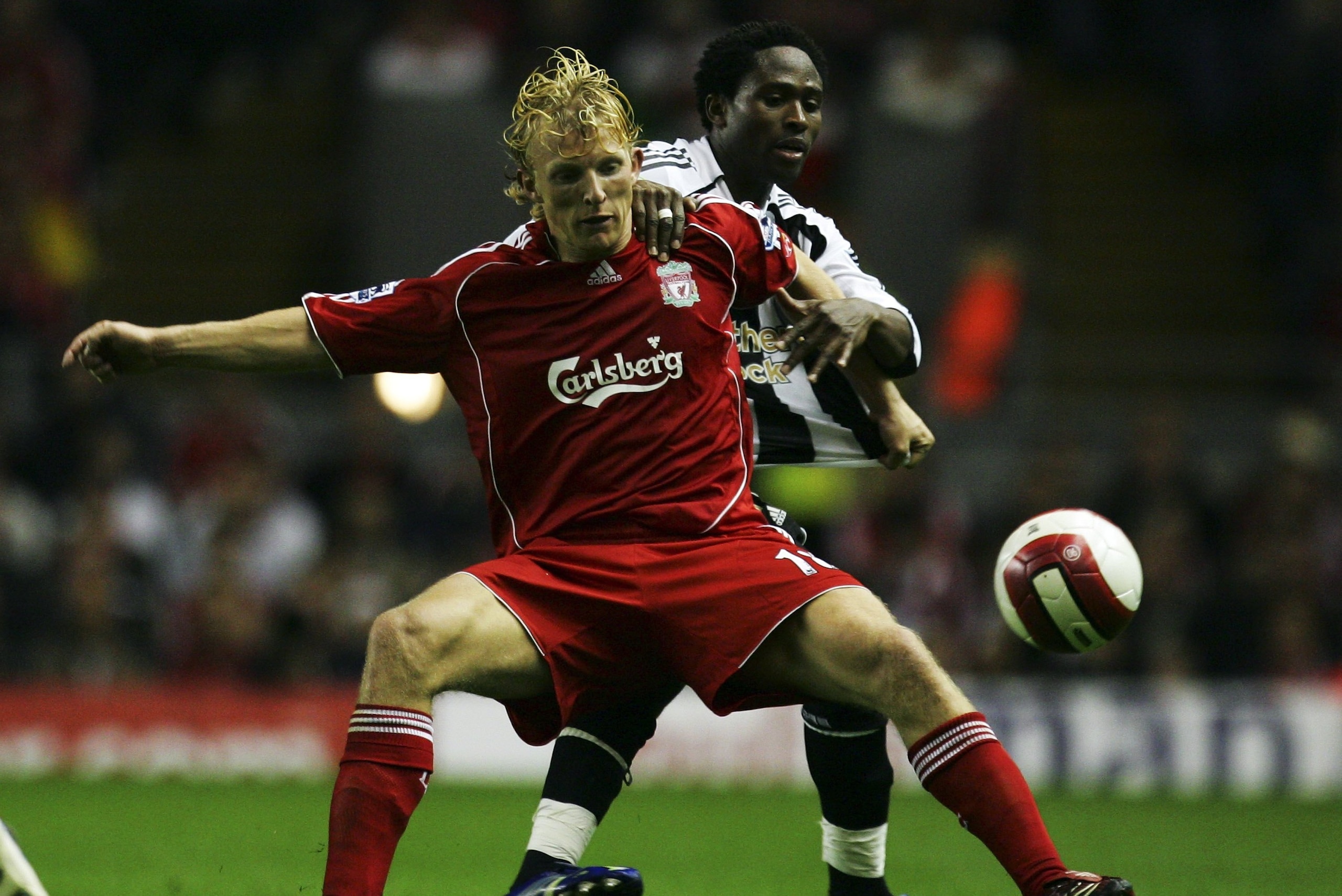 LIVERPOOL, UNITED KINGDOM - SEPTEMBER 20:Dirk Kuyt of Liverpool fights for the ball with Celestine Babayaro of Newcastle United during the Barclays Premiership match between Liverpool and Newcastle United at Anfield on September 20, 2006 in Liverpool, Eng LIVERPOOL, UNITED KINGDOM - SEPTEMBER 20:Dirk Kuyt of Liverpool fights for the ball with Celestine Babayaro of Newcastle United during the Barclays Premiership match between Liverpool and Newcastle United at Anfield on September 20, 2006 in Liverpool, Eng