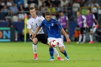 KRAKOW, POLAND - JUNE 24: Yannick Gerhardt of Germany and Domenico Berardi of Italy battle for the ball during the UEFA U21 championship match between Italy and Germany at Krakow Stadium on June 24, 2017 in Krakow, Poland. (Photo by TF-Images/Getty Images