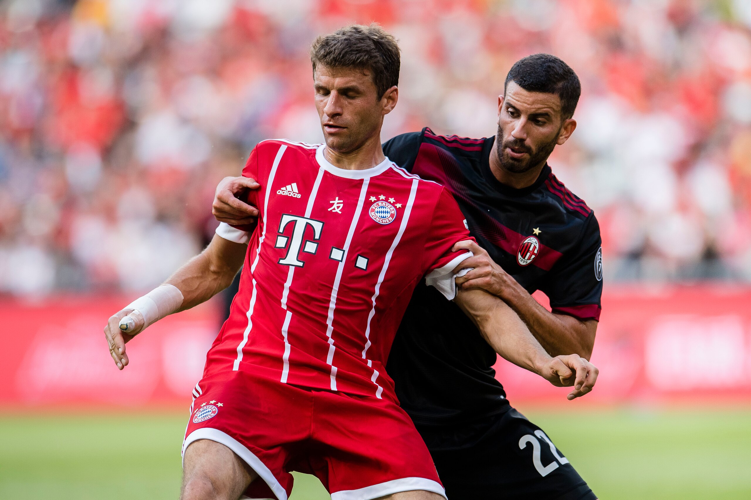 SHENZHEN, CHINA - JULY 22: Bayern Munich Forward Thomas Muller (L) fights for position with AC Milan Midfielder Mateo Musacchio (R) during the 2017 International Champions Cup China  match between FC Bayern and AC Milan at Universiade Sports Centre Stadiu