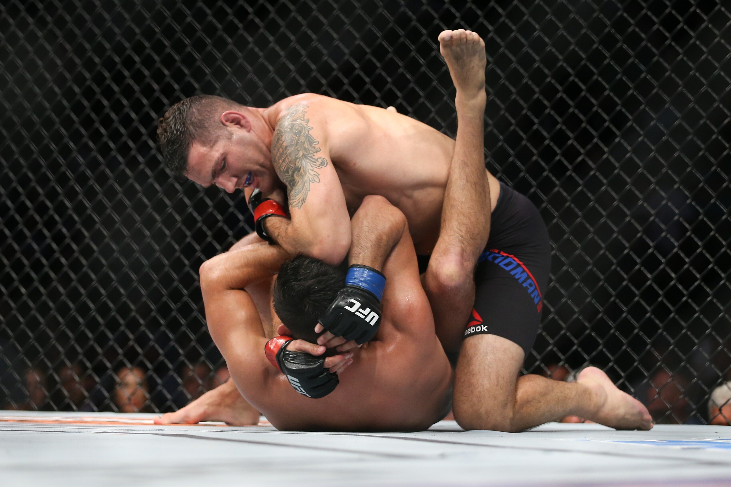 UNIONDALE, NY - JULY 22: Chris Weidman (top) lands an elbow on Kelvin Gastelum (bottom) during their UFC Fight Night middleweight bout at the Nassau Veterans Memorial Coliseum on July 22, 2017 in Uniondale, New York. (Photo by Ed Mulholland/Getty Images)