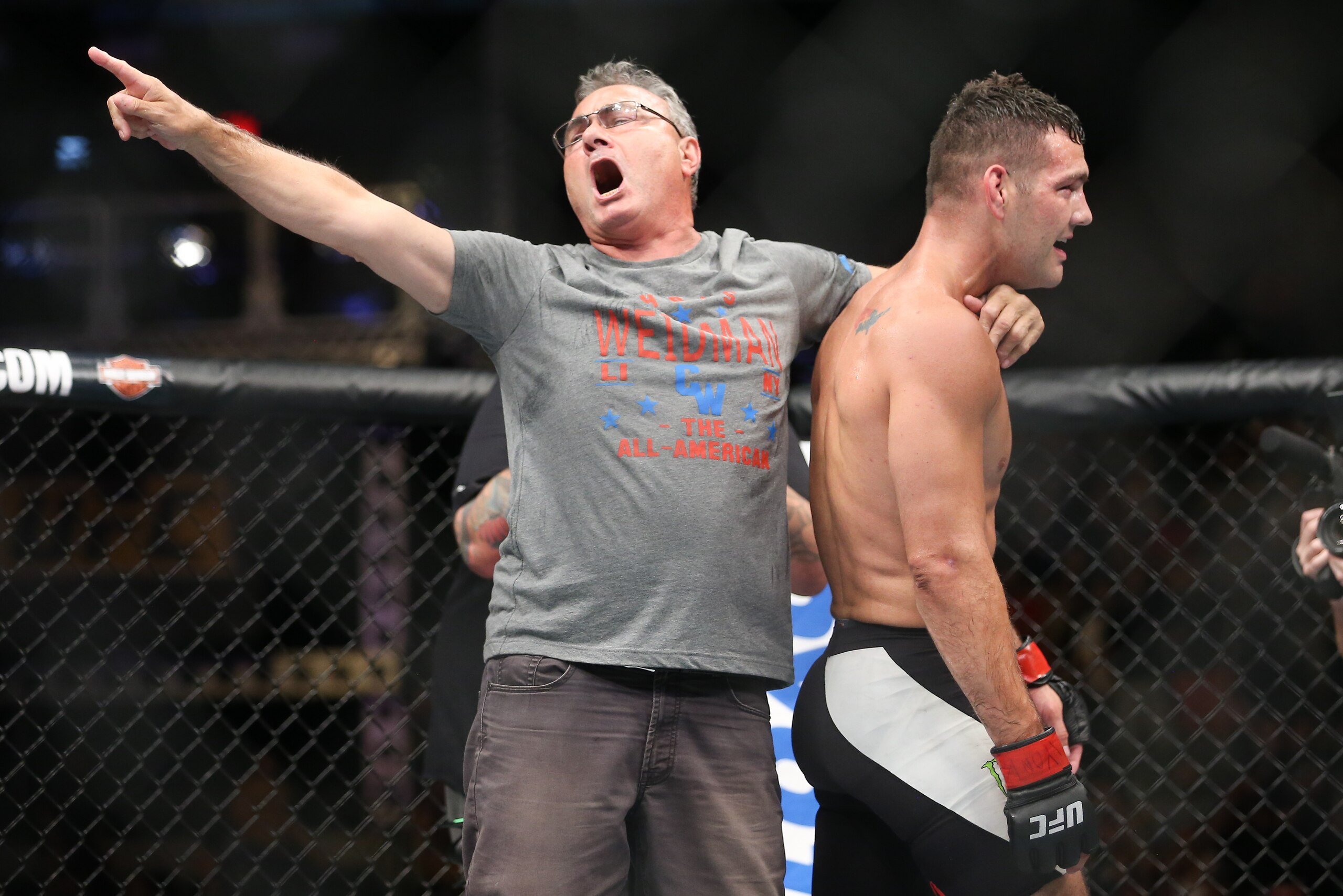 UNIONDALE, NY - JULY 22: Chris Weidman (R) and father Charlie Weidman celebrate Weidman's submission win during his UFC Fight Night middleweight bout at the Nassau Veterans Memorial Coliseum on July 22, 2017 in Uniondale, New York. (Photo by Ed Mulholland