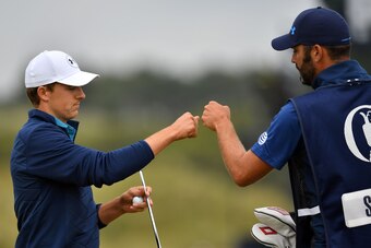US golfer Jordan Spieth and caddie Michael Greller celebrate after Spieth makes his putt on the 16th green for birdie during his final round 69 on day four of the 2017 Open Golf Championship at Royal Birkdale golf course near Southport in north west Engla