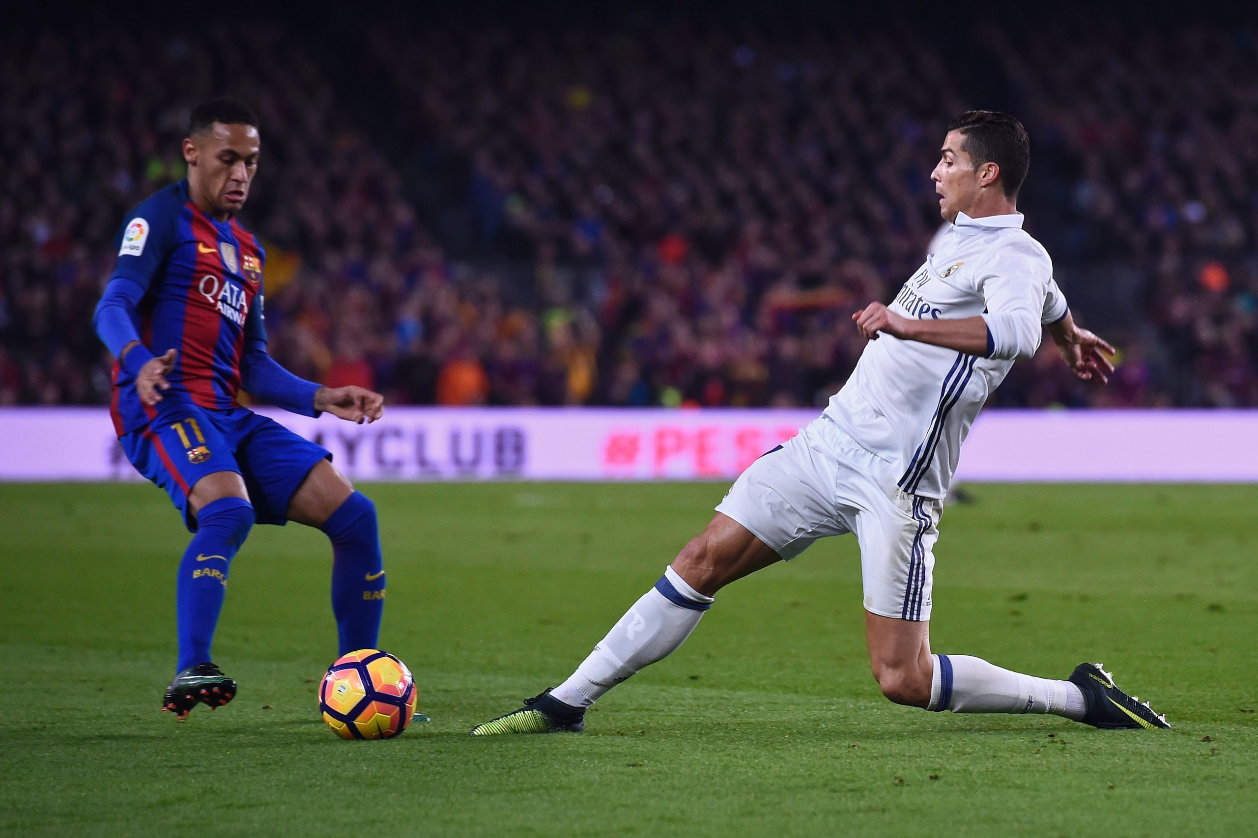 Barcelona's Brazilian forward Neymar (L) vies with Real Madrid's Portuguese forward Cristiano Ronaldo during the Spanish league football match FC Barcelona vs Real Madrid CF at the Camp Nou stadium in Barcelona on December 3, 2016. / AFP / JOSEP LAGO     