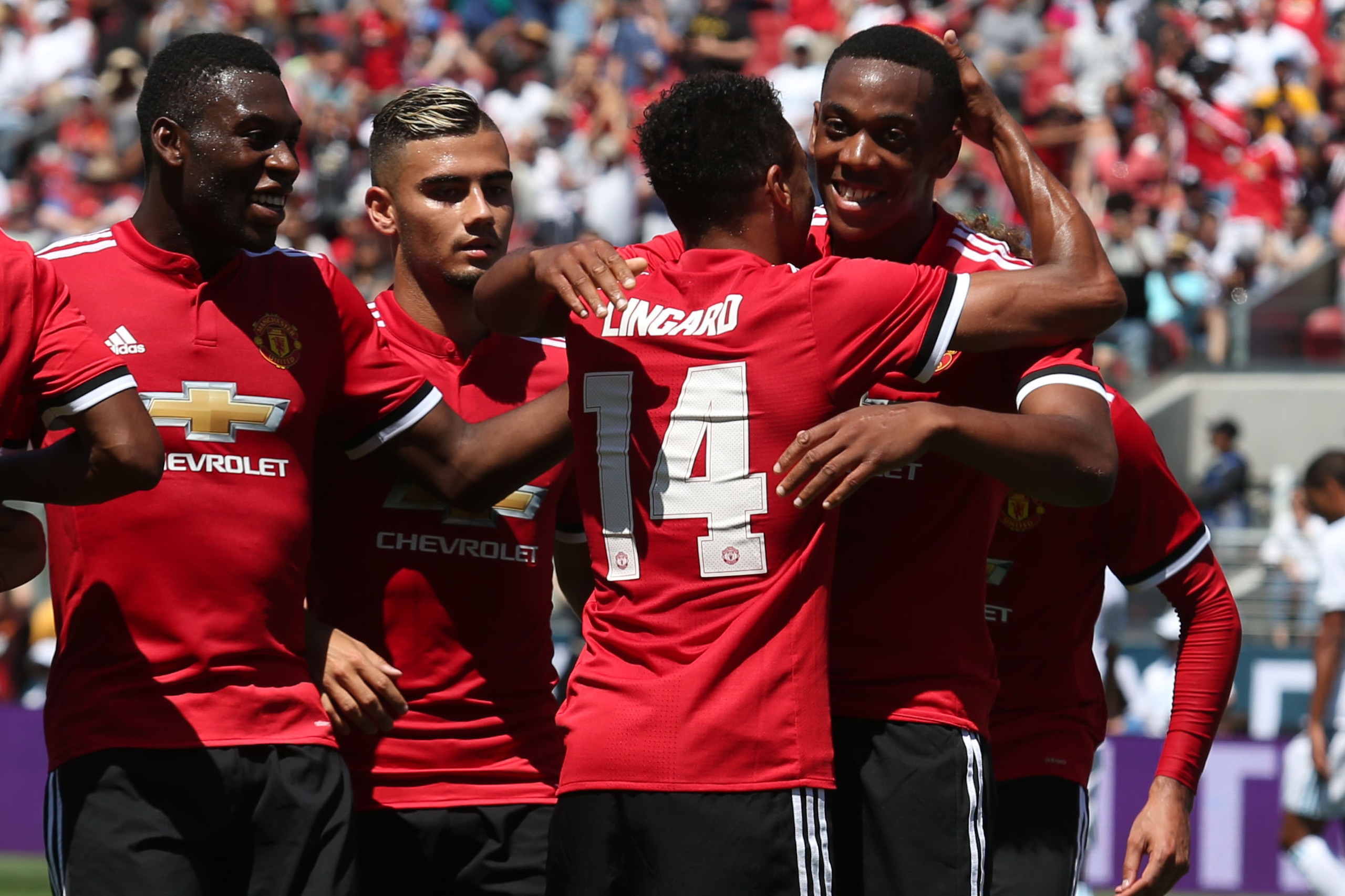 Manchester United forward Anthony Martial (right) celebrates with midfielder Jesse Lingard after Lingard scored a goal during the first half of the International Champions Cup match on July 23, 2017 in Santa Clara, California.  / AFP PHOTO / Beck Diefenba