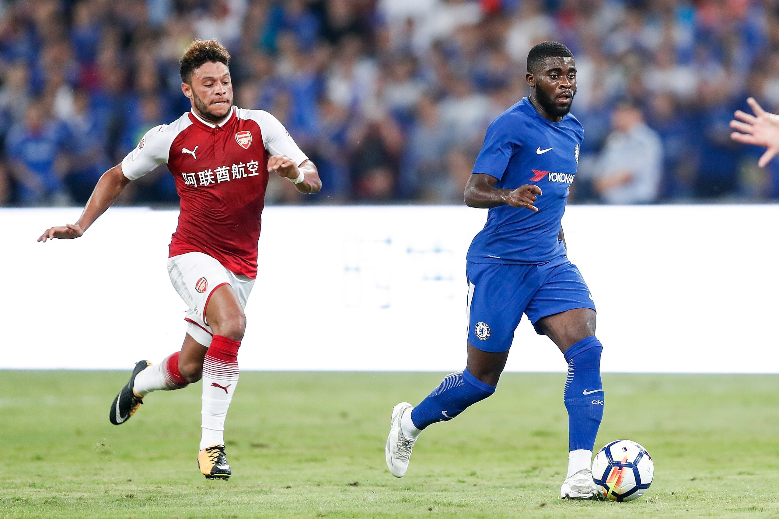 BEIJING, CHINA - JULY 22: Alex Oxlade-Chamberlain of Arsenal and Jeremie Boga of Chelsea react during the Pre-Season Friendly match between Arsenal FC and Chelsea FC at Birds Nest on July 22, 2017 in Beijing, China.  (Photo by Yifan Ding/Getty Images )